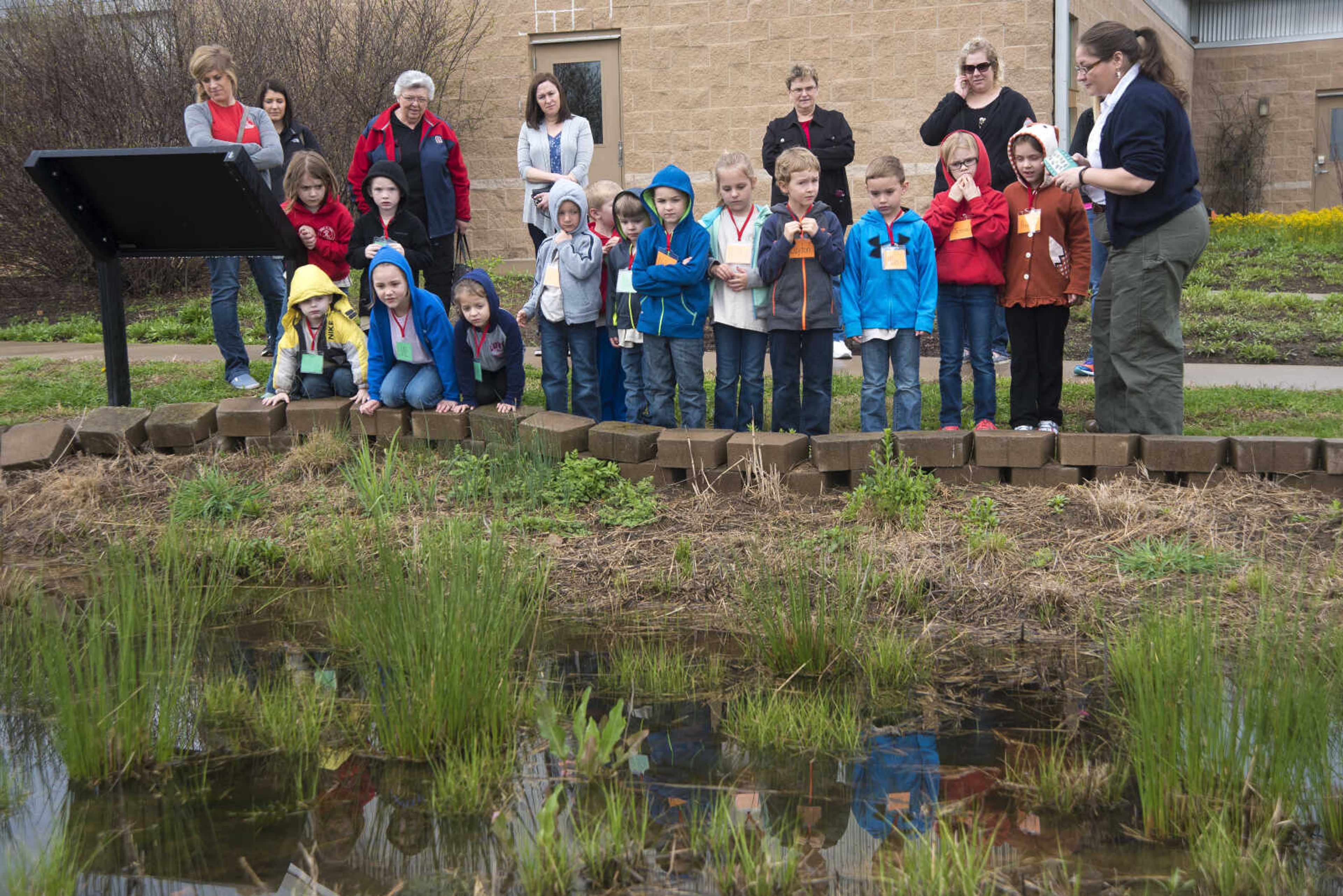 Jordi Brostoski talks to students about a frog's life cycle at the Cape Girardeau Conservation Nature Center Wednesday, March 29, 2017 in Cape Girardeau.