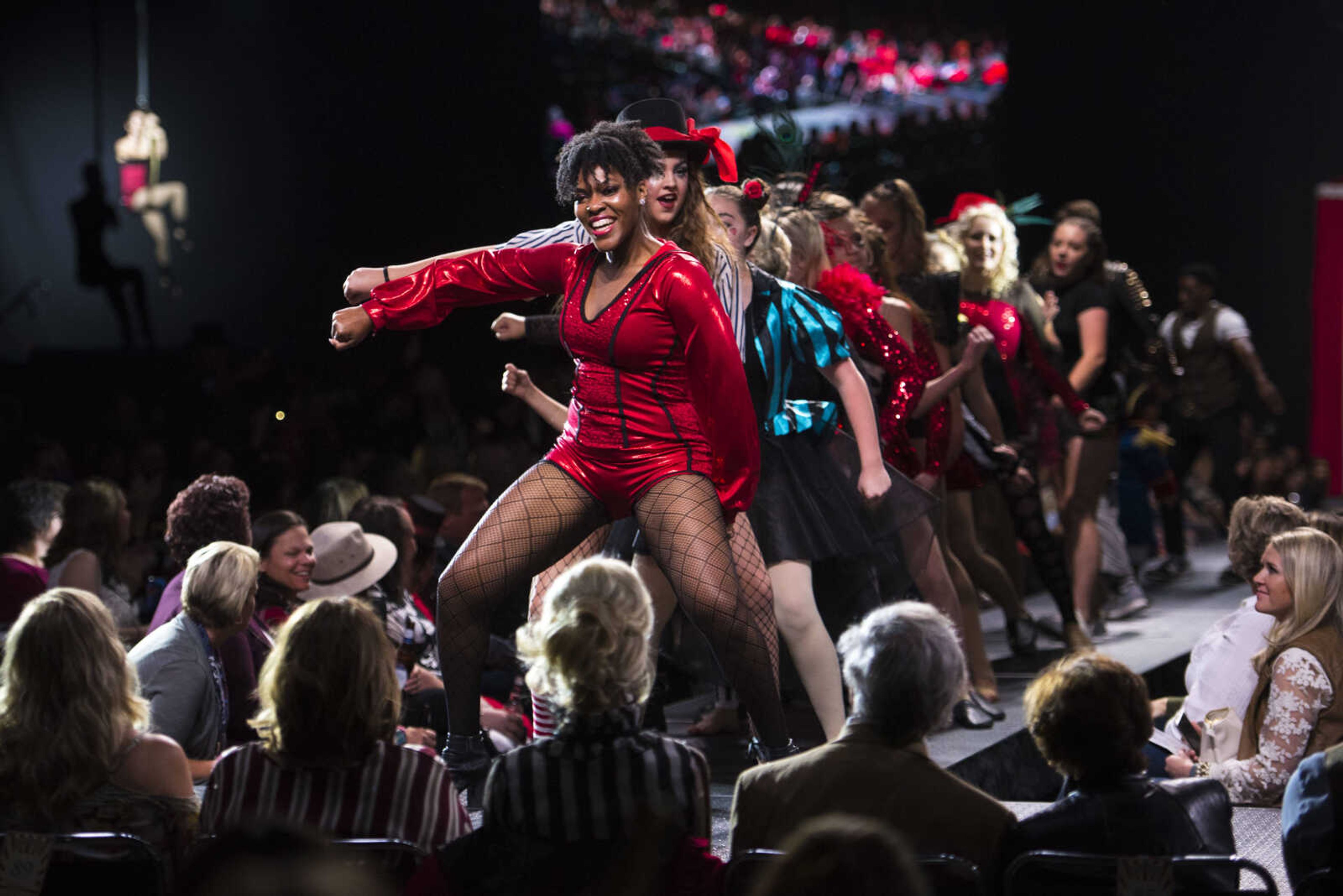 Jecala Amos, center left, leads a dance line on the runway during the VintageNOW fashion show Saturday, Oct. 20, 2018, at the Show Me Center in Cape Girardeau.