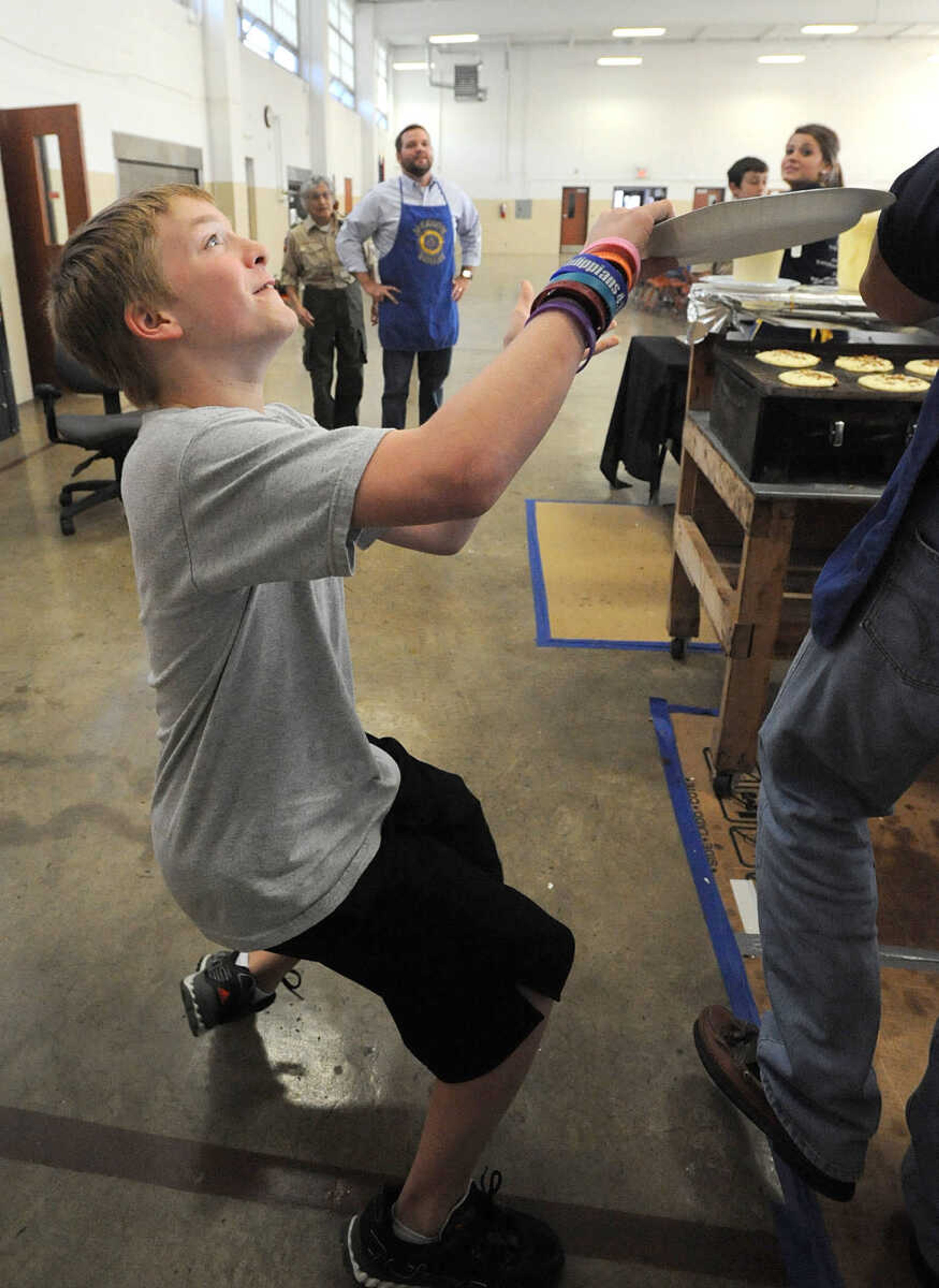 LAURA SIMON ~ lsimon@semissourian.com
Adam Walker catches a pancake hot from the griddle Tuesday, Oct. 23, 2012 during the Jackson Rotary Pancake Day at the National Guard Armory. People could pick from plain, chocolate chip, pecan and blueberry pancakes and a side of sausage.