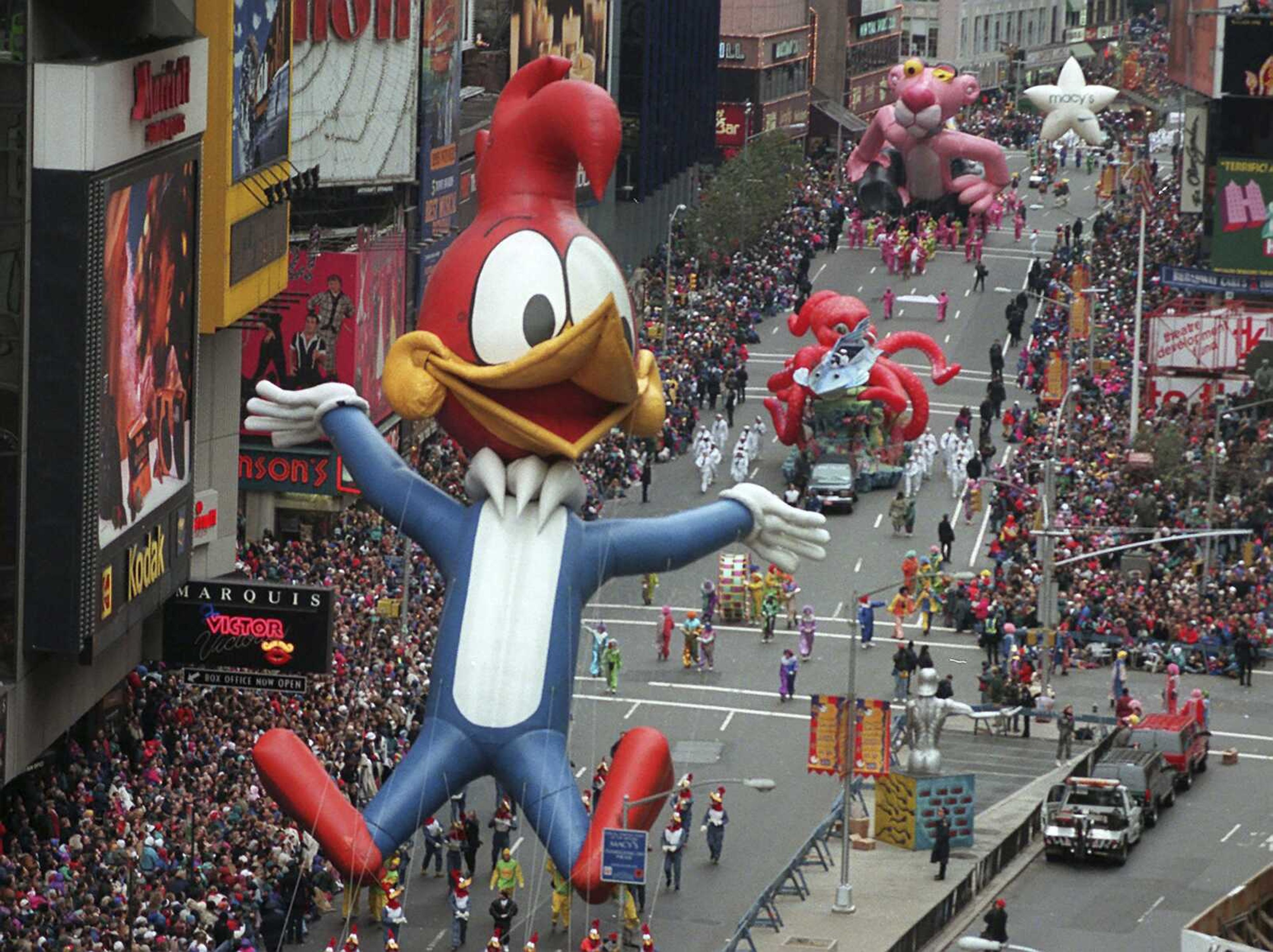 Woody Woodpecker leads a line of other balloons and floats into New York's Times Square during the 69th annual Macy's Thanksgiving Day parade on Nov. 23, 1995.