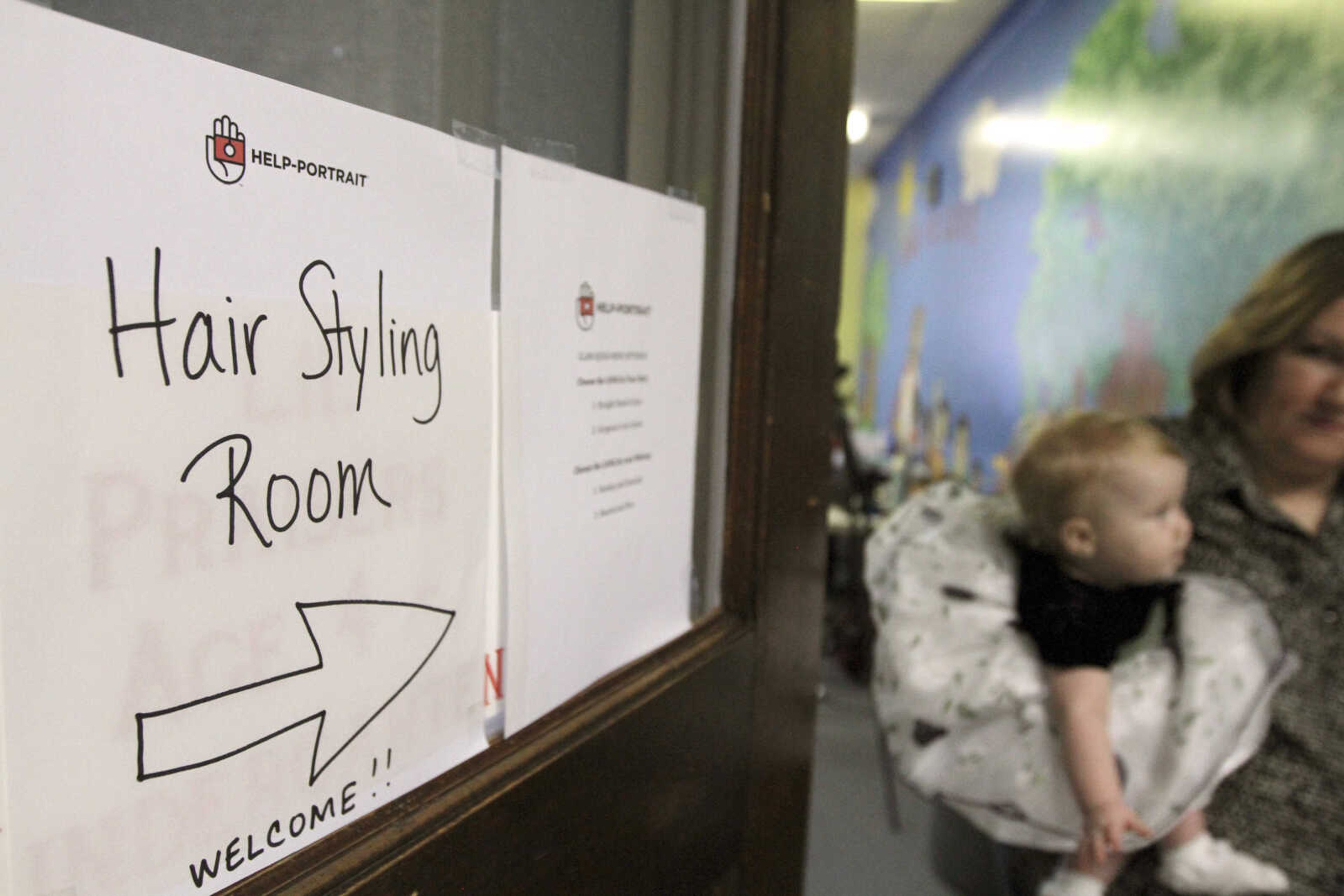 GLENN LANDBERG ~ glandberg@semissourian.com

A sign directs people to the hair and make-up room during the fifth annual Help-Portrait event Saturday, Dec. 6, 2014 at the House of Hope in Cape Girardeau.