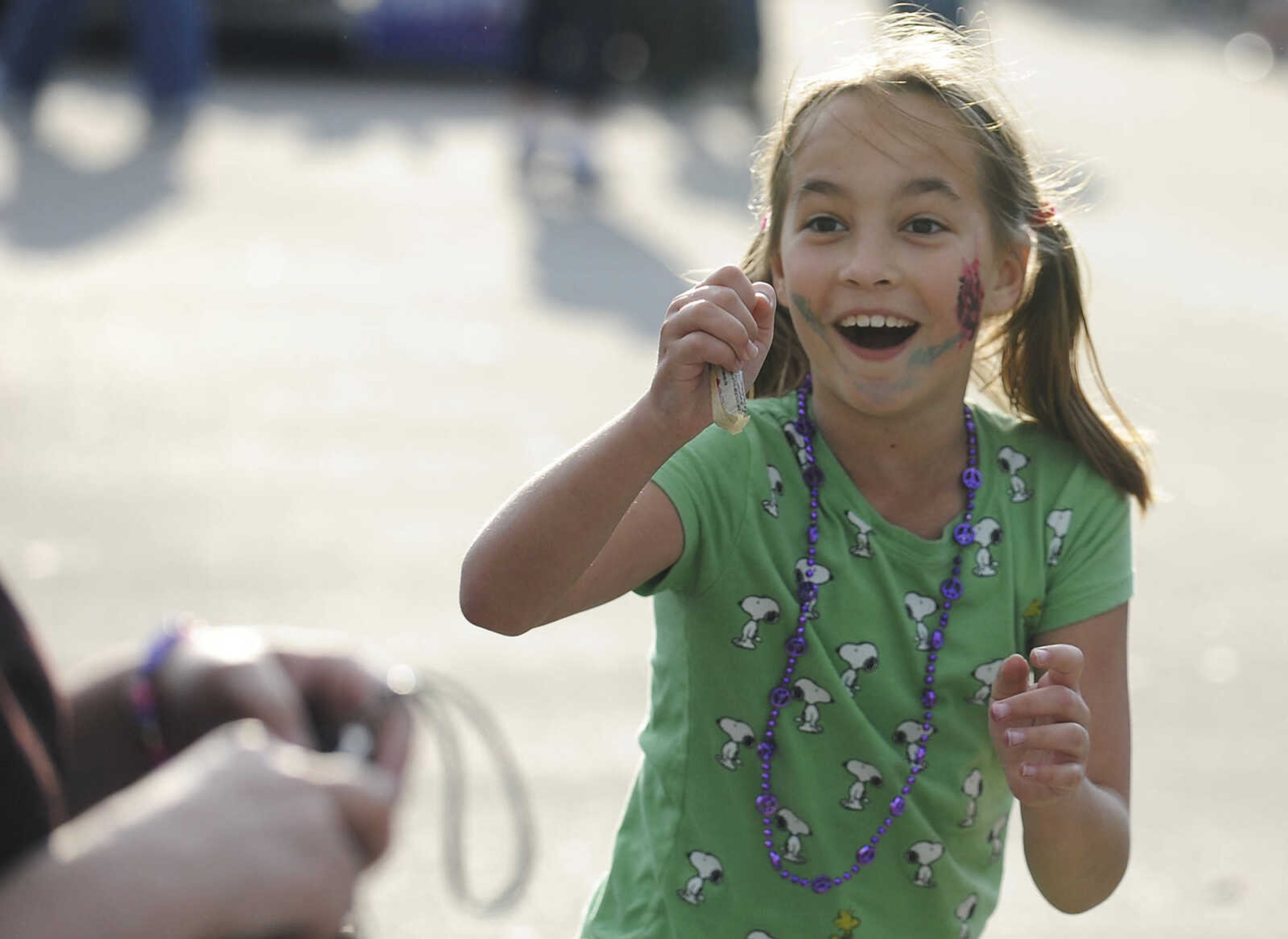 Kamea Foster, 9, reacts after catching a piece of candy during the Perryville Mayfest Parade Friday, May 10, in Perryville, Mo. This year's Mayfest theme is Peace, Love, Perryville Mayfest.