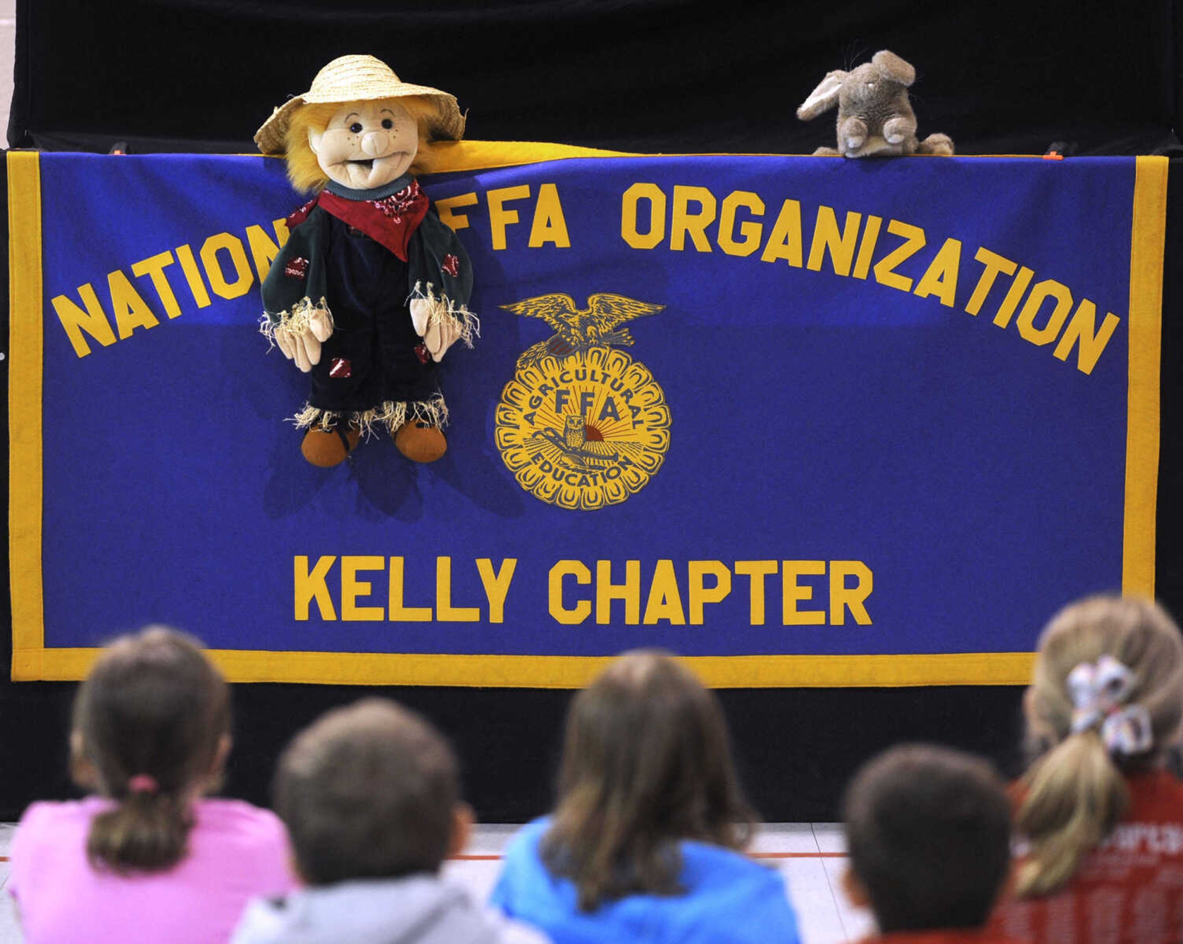 A puppet show presented by FFA students at Kelly High School welcomes the third-grade students to Farm Day.