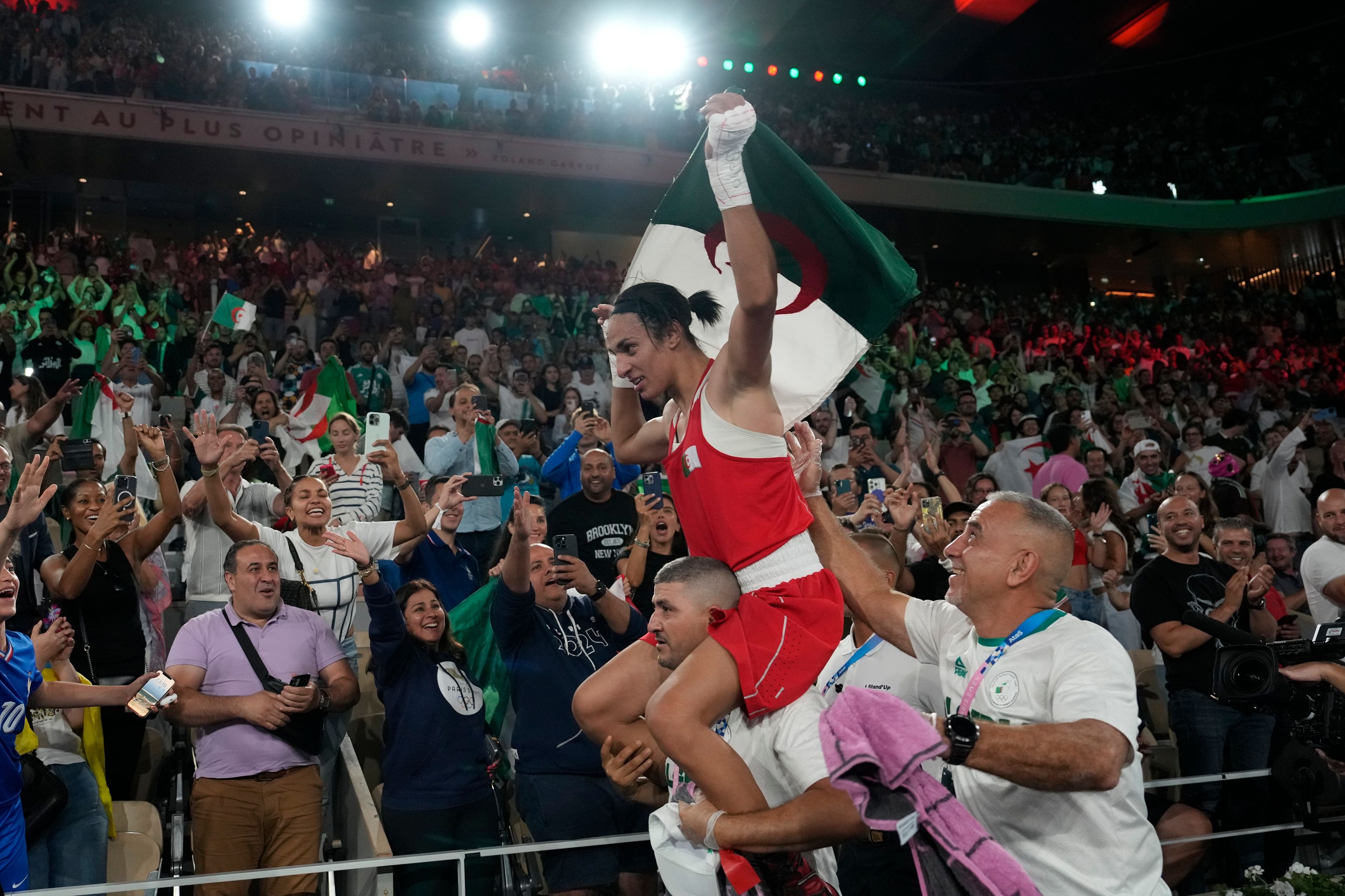 Algeria's Imane Khelif celebrates after defeating China's Yang Liu to win gold in their women's 66 kg final boxing match at the 2024 Summer Olympics, Friday, Aug. 9, 2024, in Paris, France. (AP Photo/Ariana Cubillos)