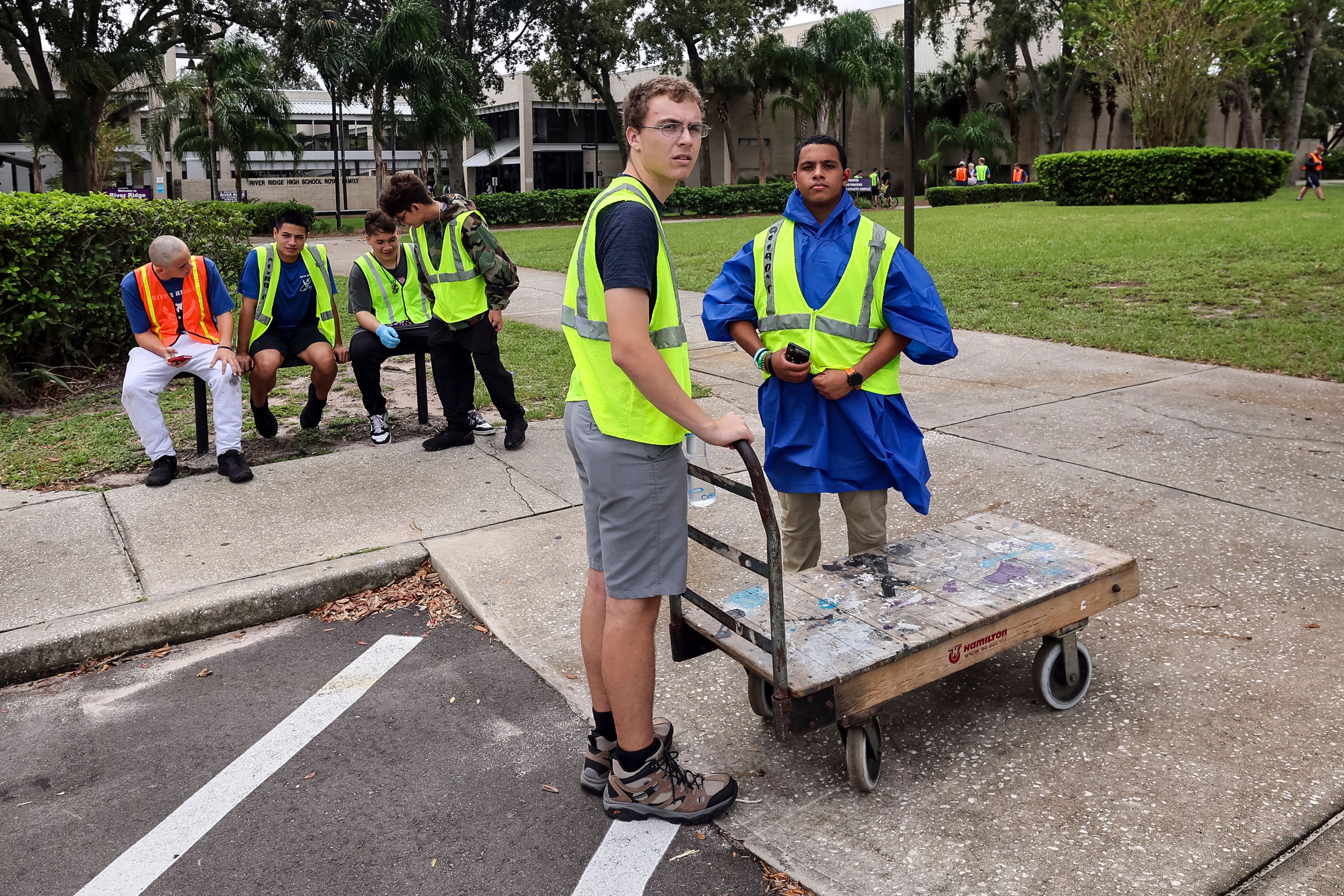 Members of the AFJROTC squadron of River Ridge High School stage to help evacuees load in as the school is ready for use as a shelter in preparation for Hurricane Milton on Monday, Oct. 7, 2024, in New Port Richey, Fla. (AP Photo/Mike Carlson)