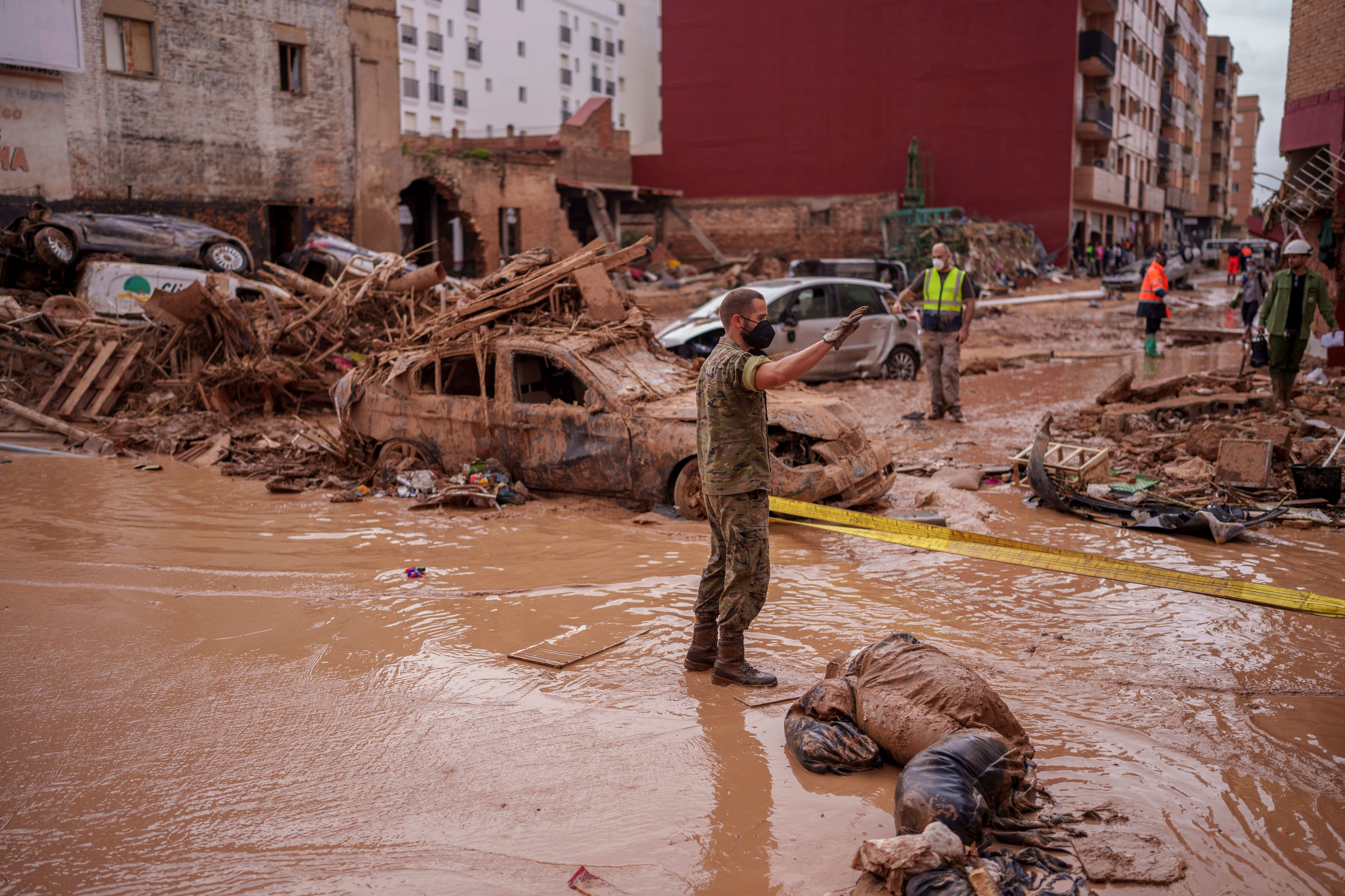 A soldier works in an area affected by floods in Catarroja, Spain, Sunday, Nov. 3, 2024. (AP Photo/Manu Fernandez)