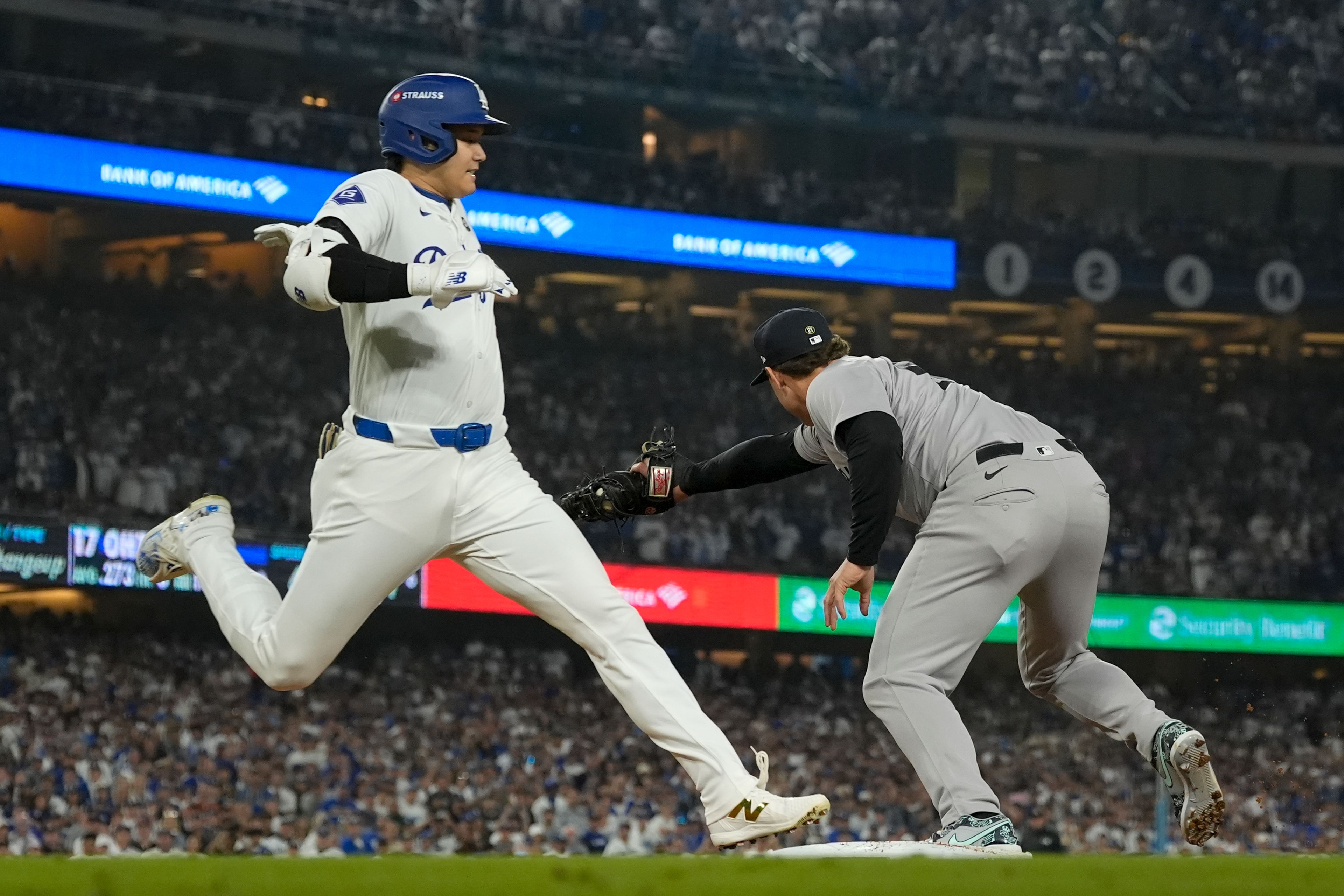 Los Angeles Dodgers' Shohei Ohtani is forced out at first by New York Yankees first baseman Anthony Rizzo during the sixth inning in Game 1 of the baseball World Series, Friday, Oct. 25, 2024, in Los Angeles. (AP Photo/Ashley Landis)