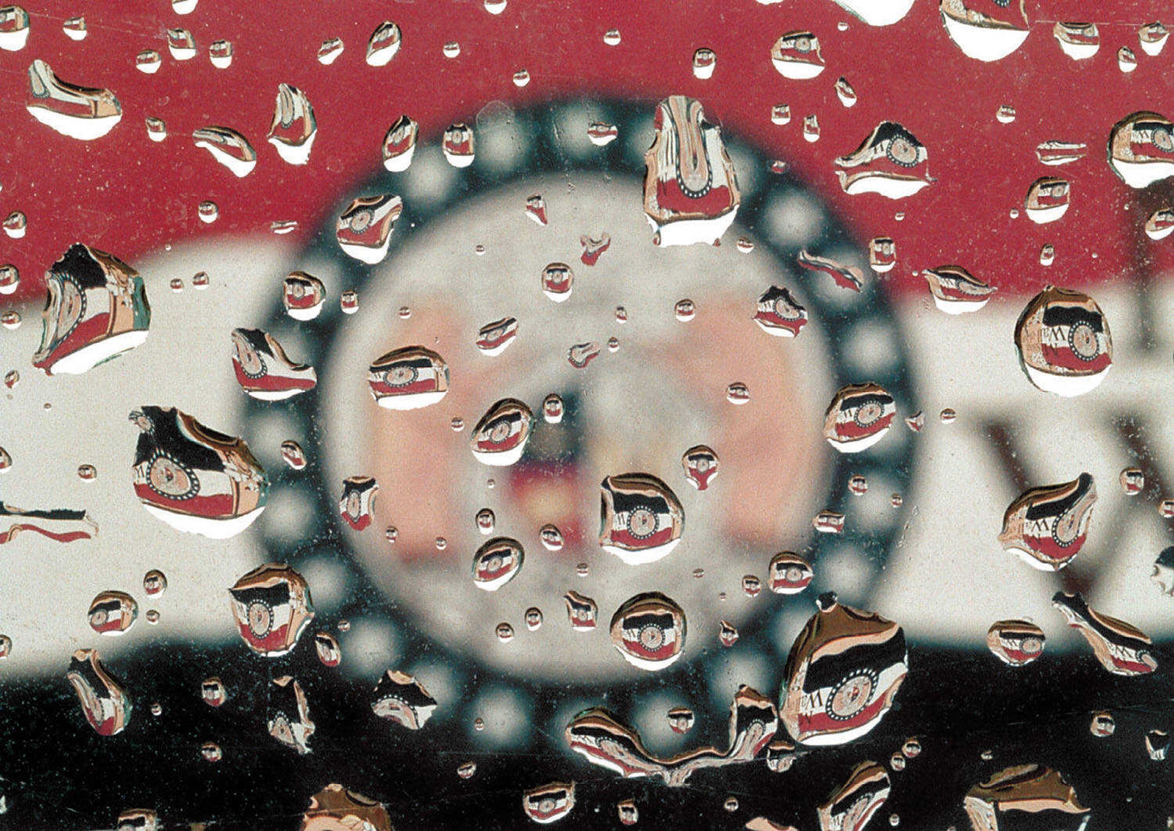 The Missouri Flag on the original Missouri Wall of Fame floodwall mural is reflected in raindrops on a car window in downtown Cape Girardeau. (Fred Lynch)