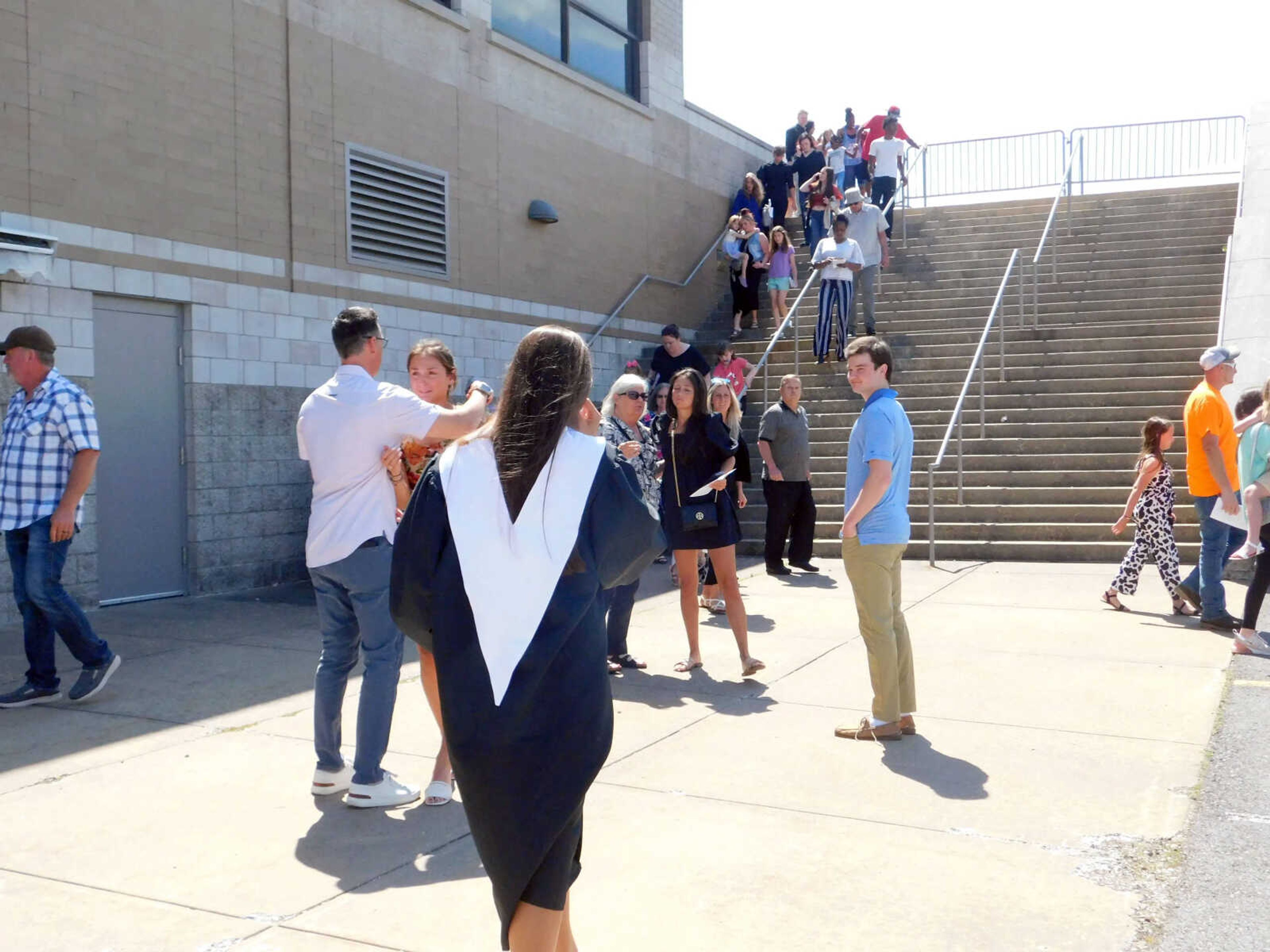 Attendees console one another and file out of the Show Me Center on the campus of Southeast Missouri State University following a shooting at the Cape Central High School graduation ceremony Sunday, May 19, in Cape Girardeau.