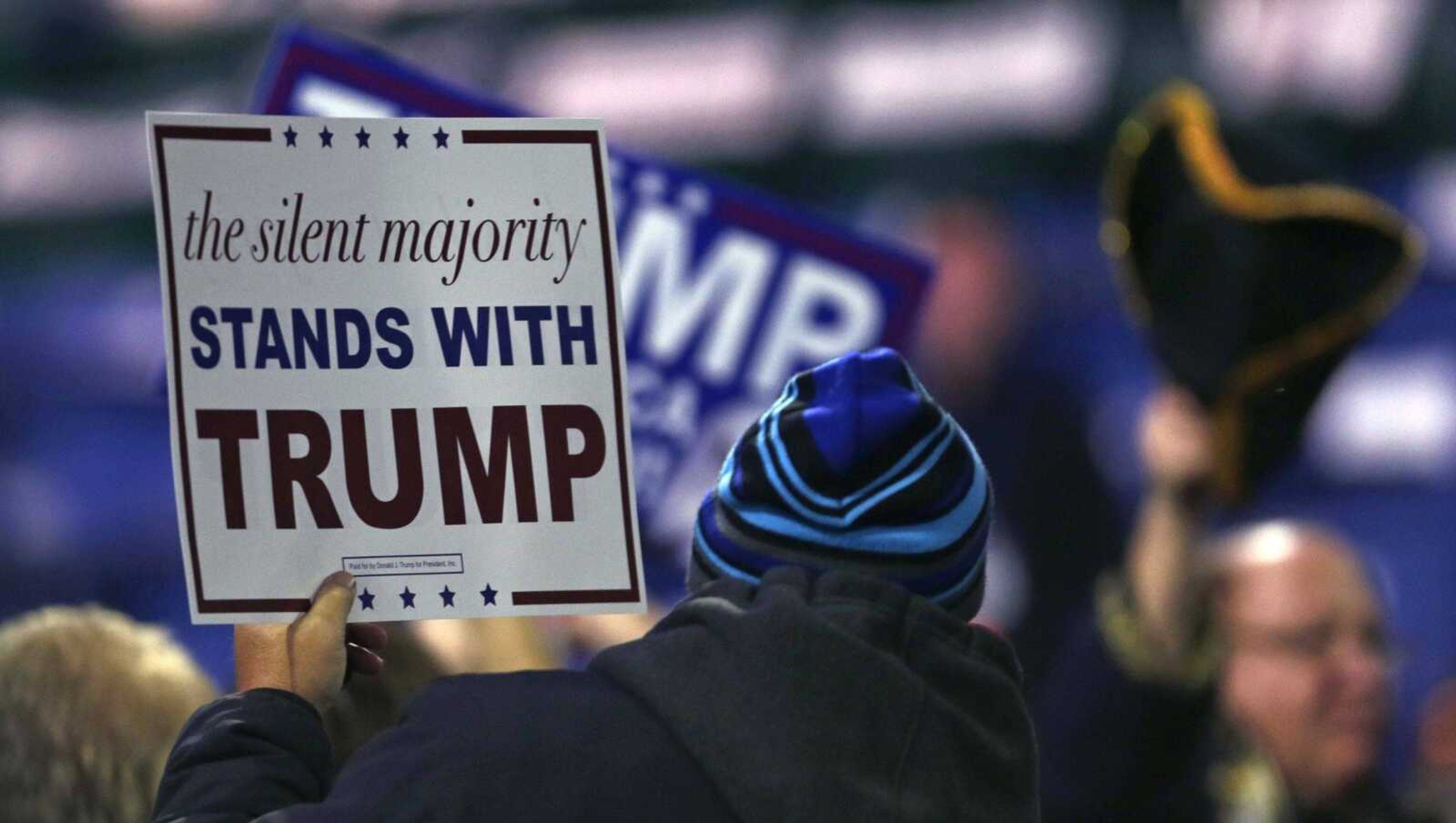 Supporters hold up signs for Republican presidential candidate Donald Trump before a campaign stop at the Tsongas Center in Lowell, Massachusetts. (Charles Krupa ~ Associated Press)