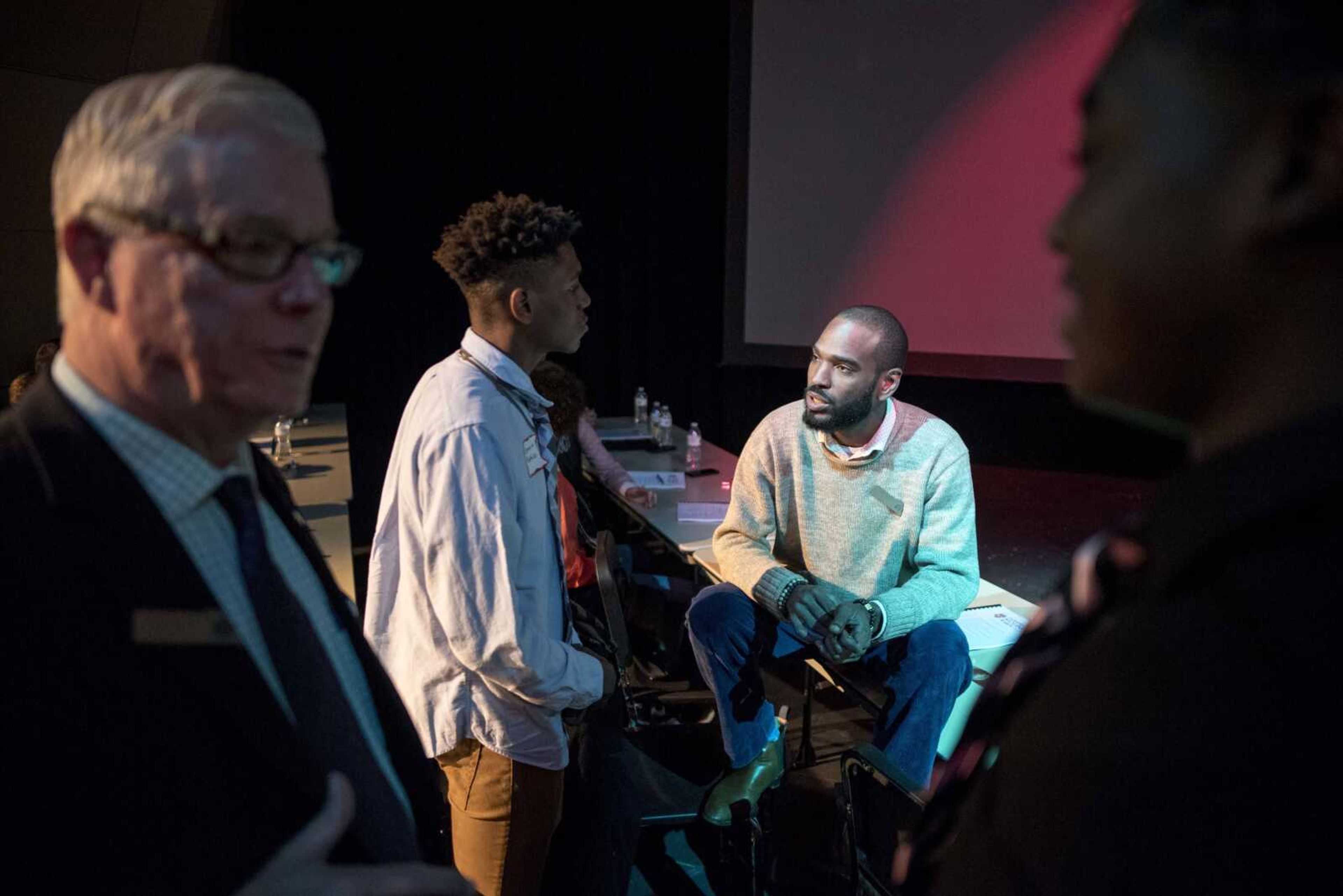 Honorable Young Men Club member Demarius Mathies, center left, talks with Representative Wiley Price, seated, while former Missouri Lt. Gov. Peter Kinder, far left, talks with Glen Nesby, far right, during a visit from regional politicians and members of the Missouri state legislature's black caucus Friday, Oct. 25, 2019, at Cape Central High School.