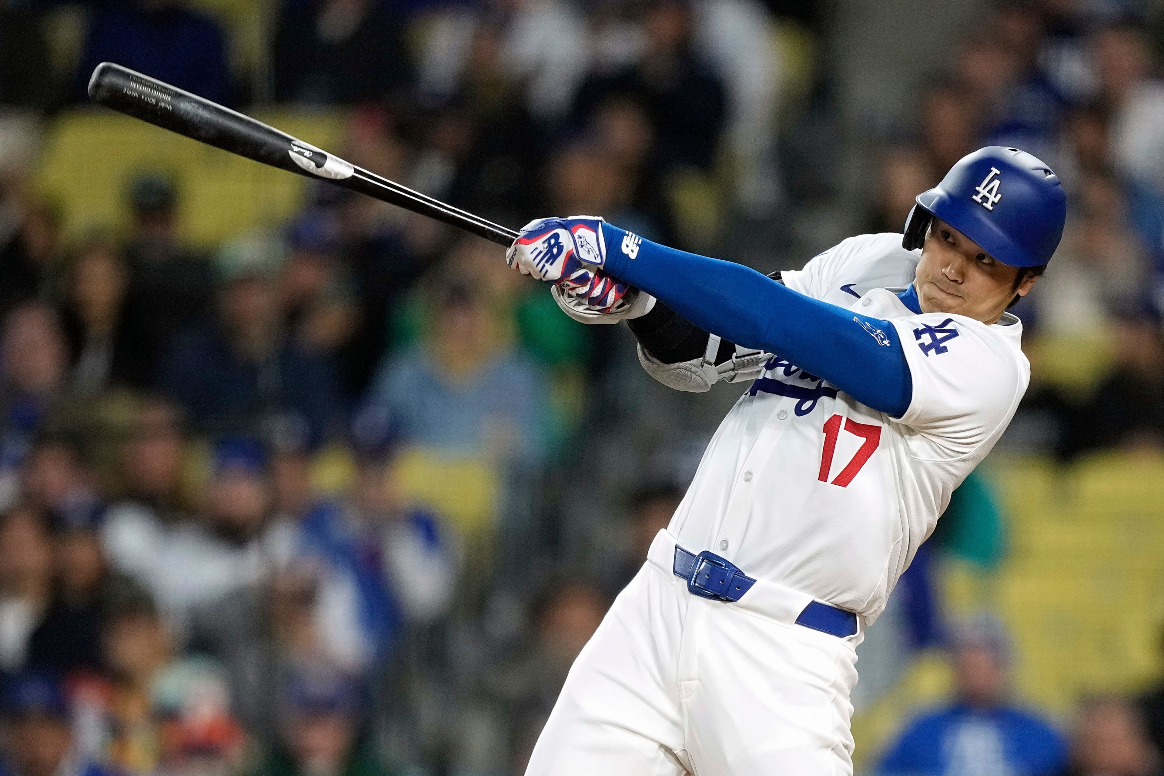 Los Angeles Dodgers' Shohei Ohtani hits a solo home run during the first inning of a baseball game against the San Diego Padres Friday, April 12, 2024, in Los Angeles. (AP Photo/Mark J. Terrill)