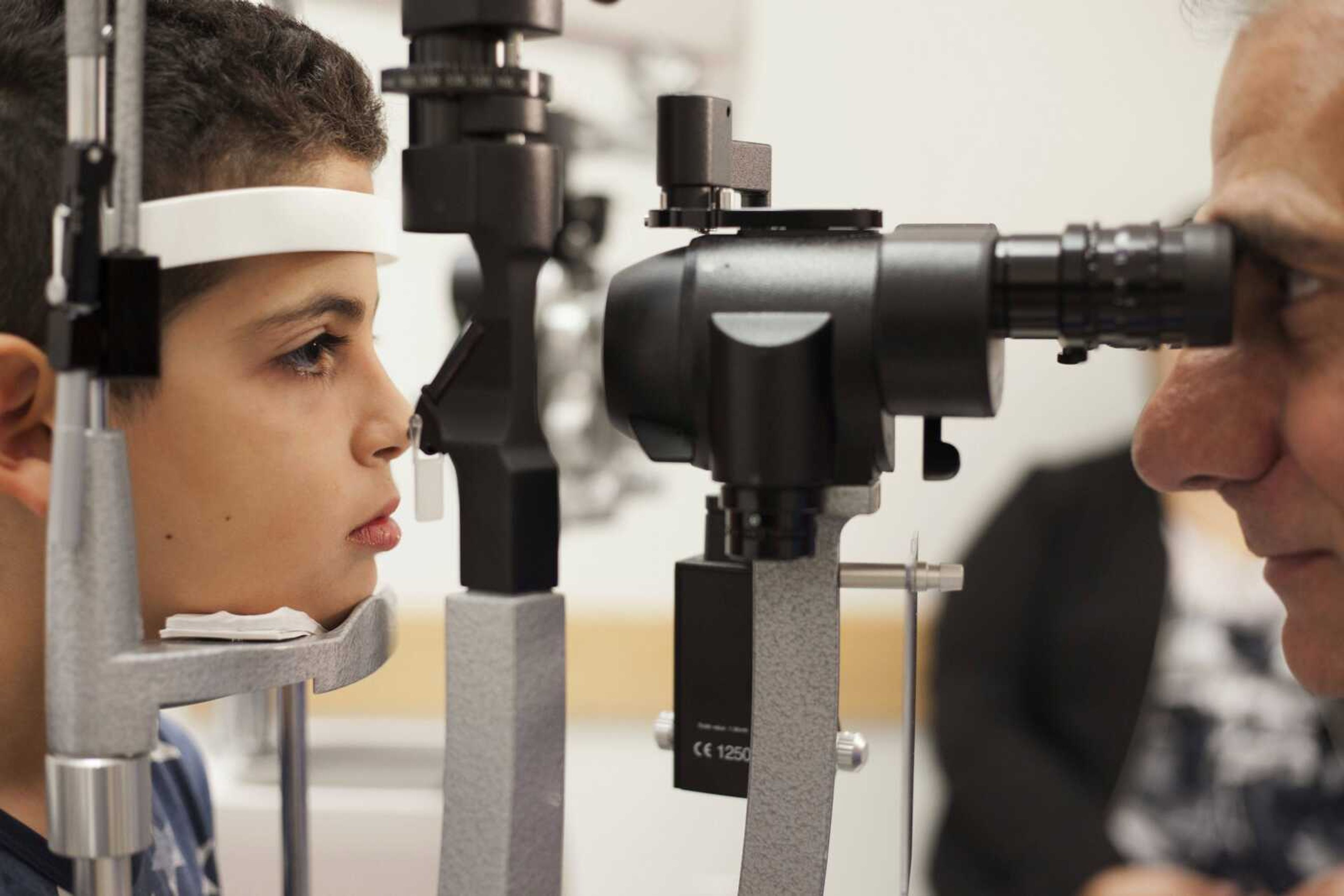 Dr. Albert Maguire checks the eyes of Misa Kaabali, 8, at the Children's Hospital of Philadelphia. Misa was 4-years-old when he received his gene therapy treatment. The treatment will cost $850,000.