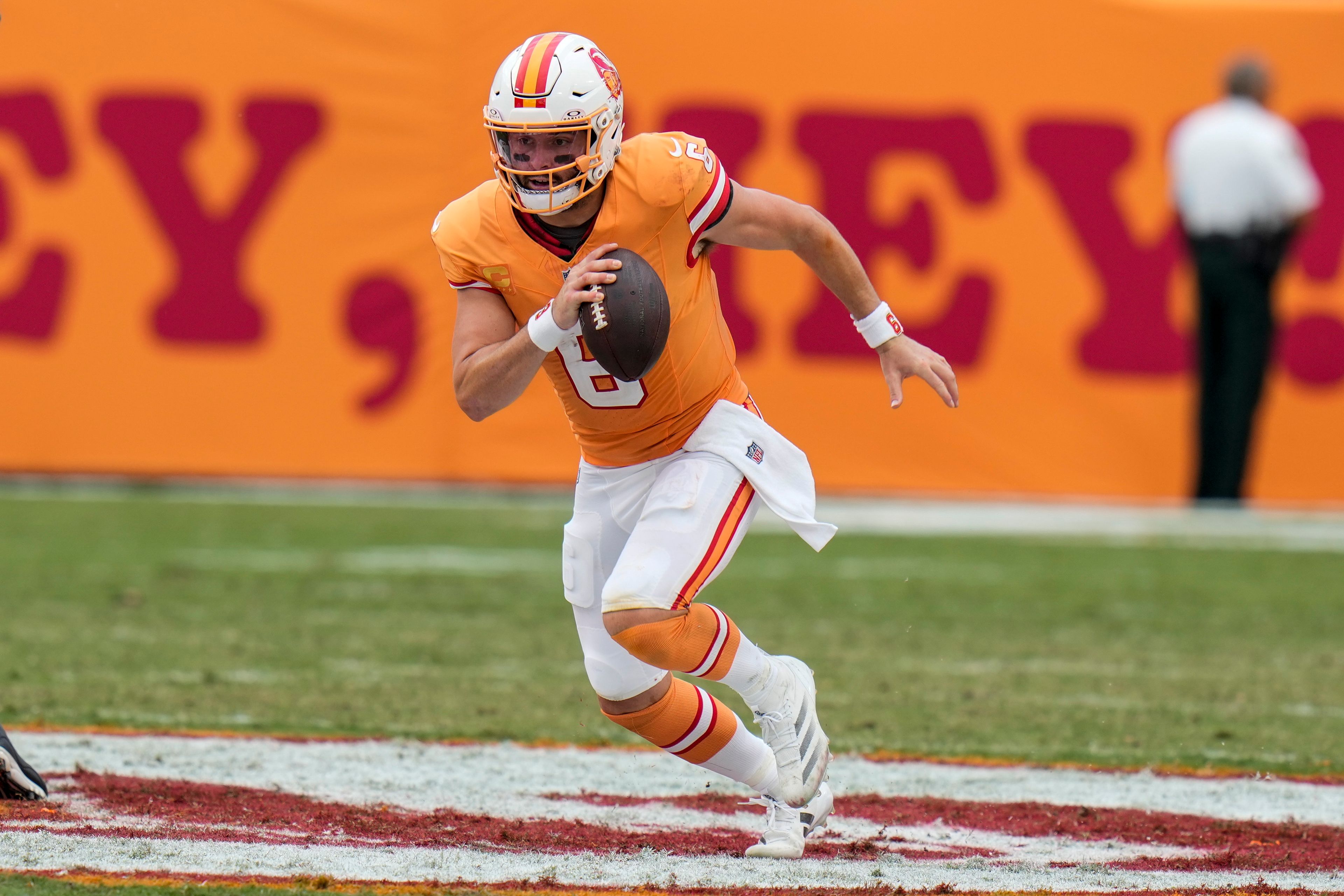 Tampa Bay Buccaneers quarterback Baker Mayfield (6) runs out of the pocket for a first down against the Atlanta Falcons during the second half of an NFL football game, Sunday, Oct. 27, 2024, in Tampa. (AP Photo/Chris O'Meara)