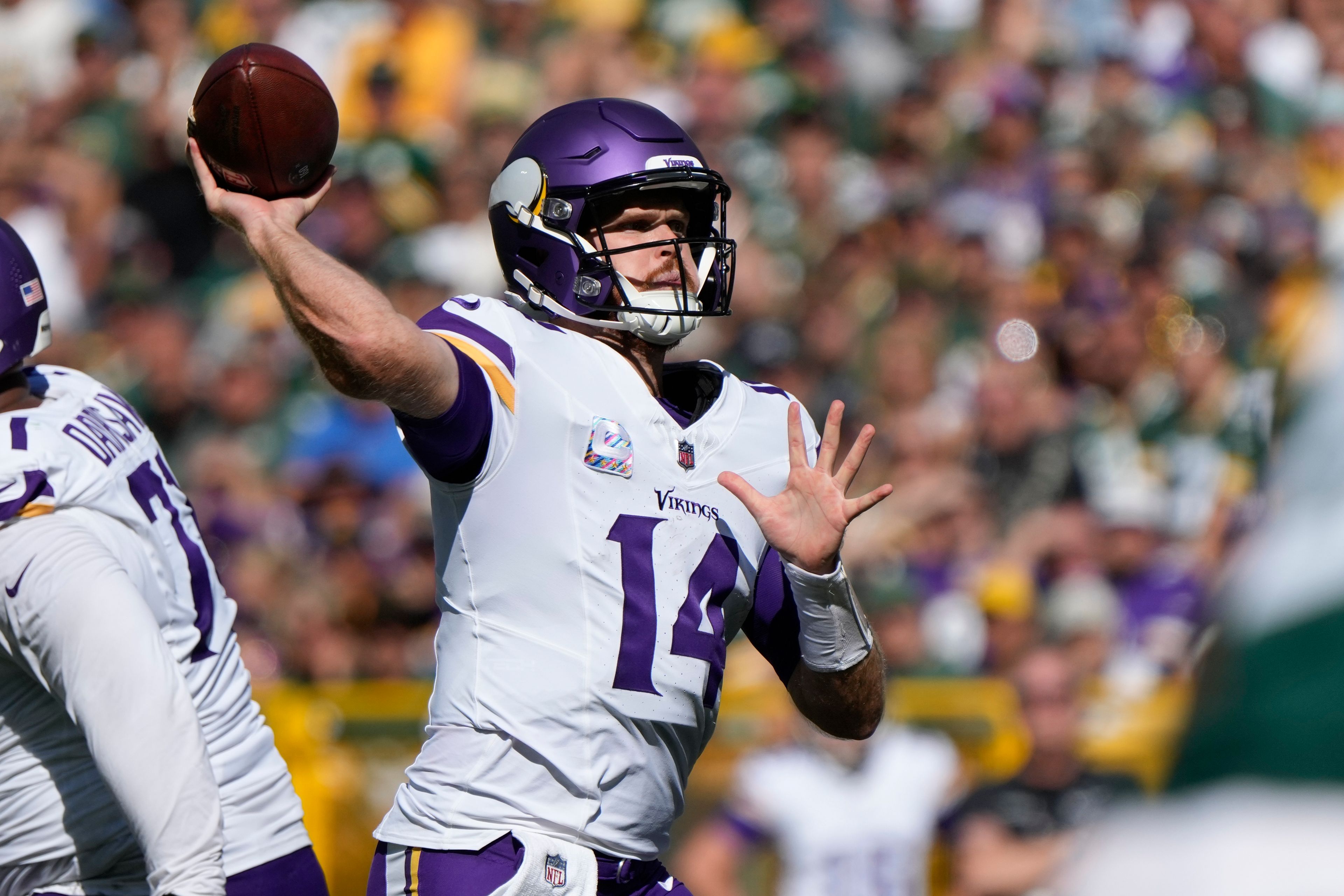 Minnesota Vikings quarterback Sam Darnold (14) looks to throw a pass during the second half of an NFL football game against the Green Bay Packers, Sunday, Sept. 29, 2024, in Green Bay, Wis. (AP Photo/Morry Gash)