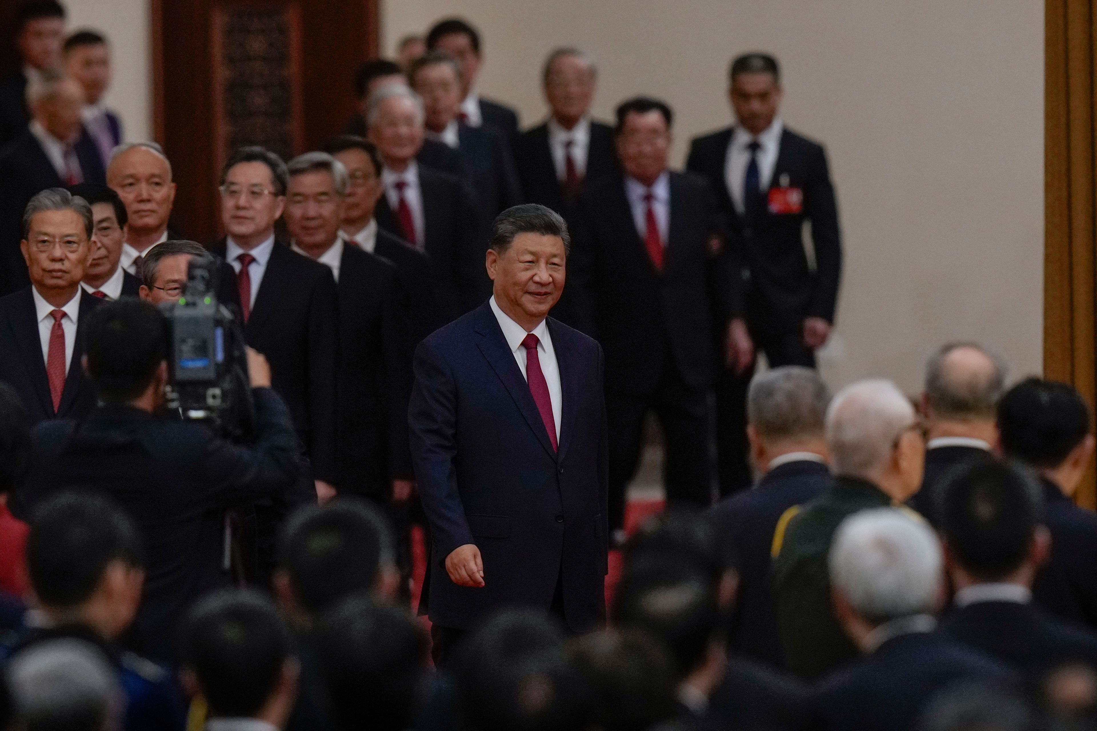 Chinese President Xi Jinping, center, is followed by high-ranking Chinese officials, arrive for a dinner marking the 75th anniversary of the founding of the People's Republic of China, at the Great Hall of the People in Beijing, Monday, Sept. 30, 2024. (AP Photo/Andy Wong)