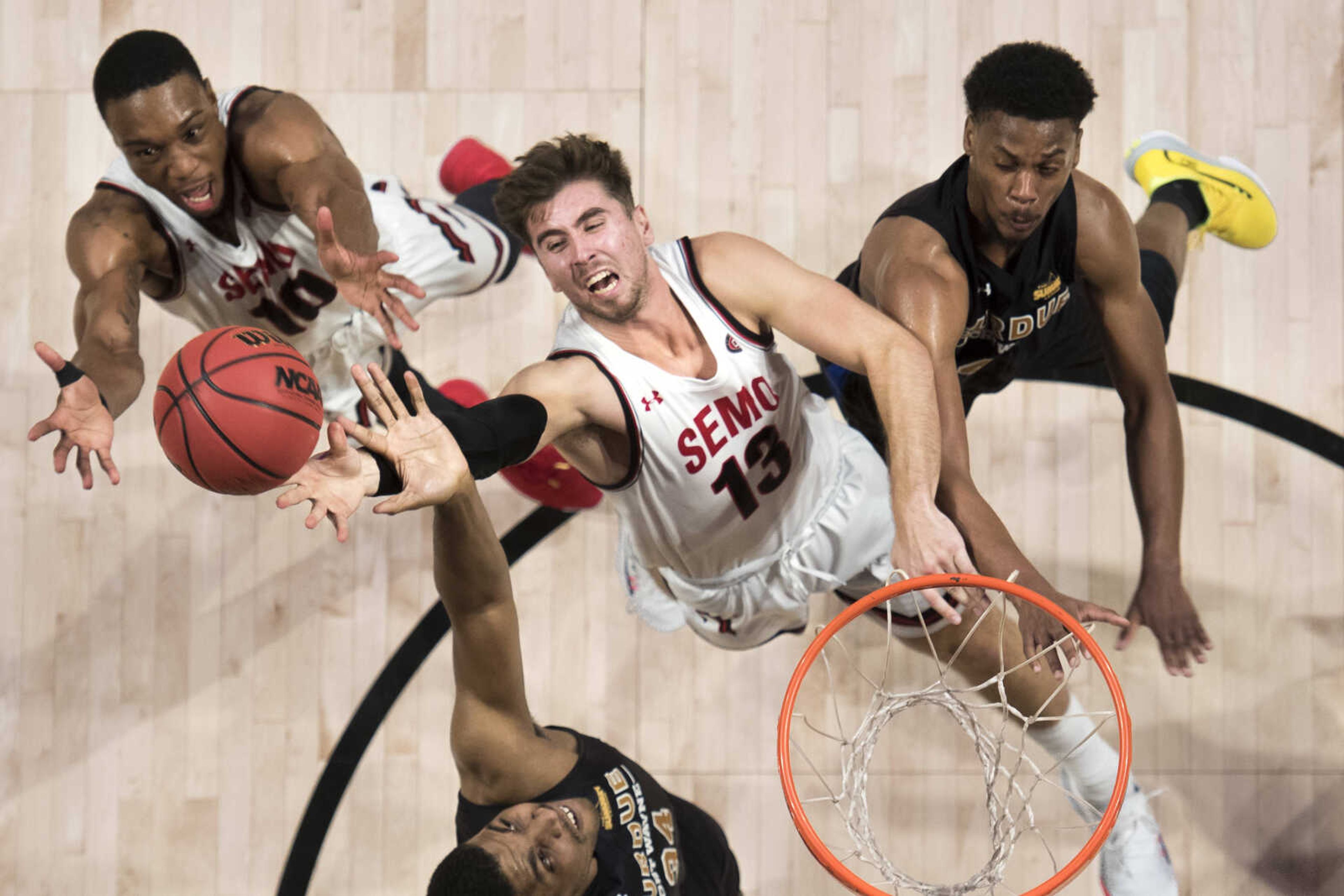 Southeast Missouri State's Isaiah Gable (13) and Quatarrius Wilson (10) reach for a rebound amid Purdue Fort Wayne defenders Cameron Benford (34) and Marcus Deberry (41) during the second half of a men's basketball game Sunday, Nov. 10, 2019, at the Show Me Center in Cape Girardeau.