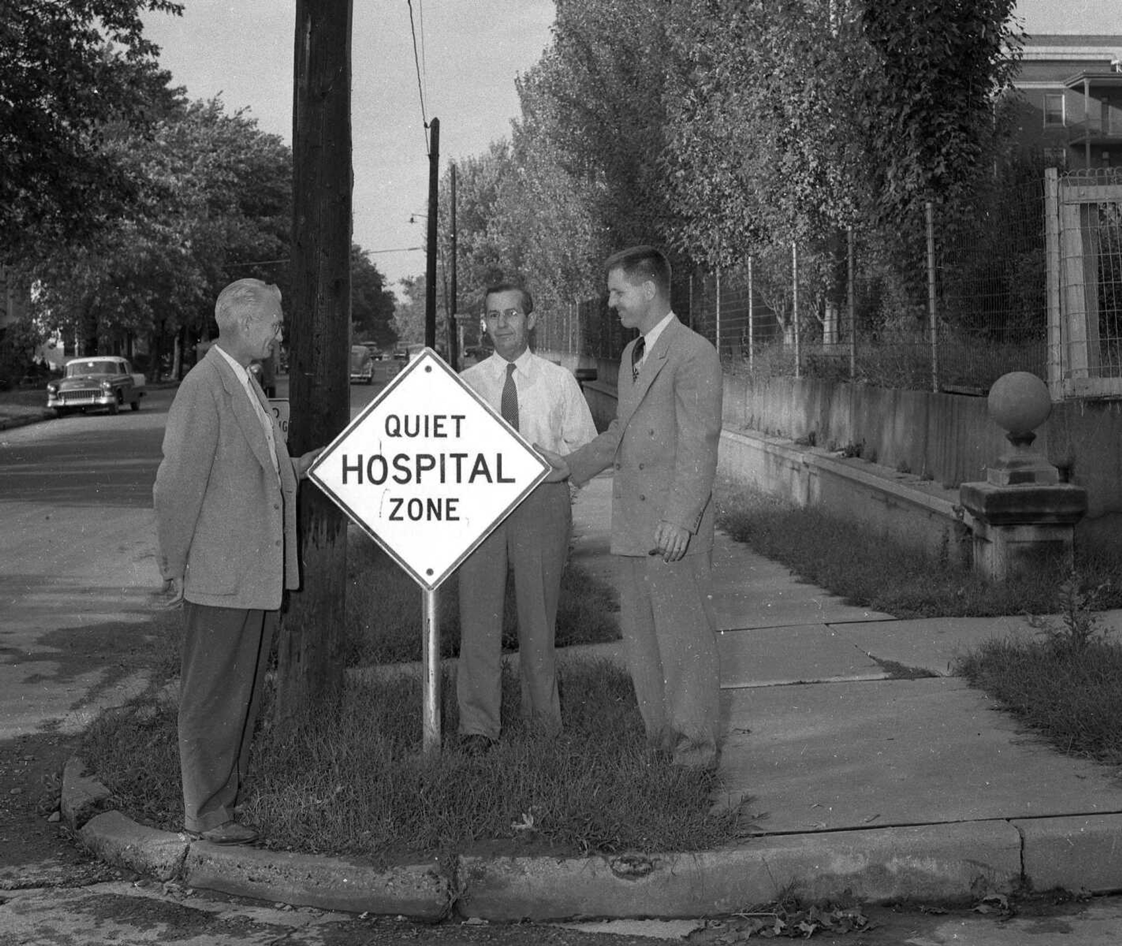 Oct. 7, 1955 Southeast Missourian.
Shown looking at one of the ten new signs which mark the three hospital zones of the city are, from the left, Police Commissioner Leon McLaughlin, George Vandeven and Dr. D.G. Ruopp, grand knight St. Vincent’s Council Knights of Columbus, the organization which purchased the signs. They were installed by city workmen. Of a special luminous paint, the signs shine brightly in the headlights of a car at night. It is hoped the signs will help to curb street noises in the hospital areas. (G.D. Fronabarger/Southeast Missourian archive)