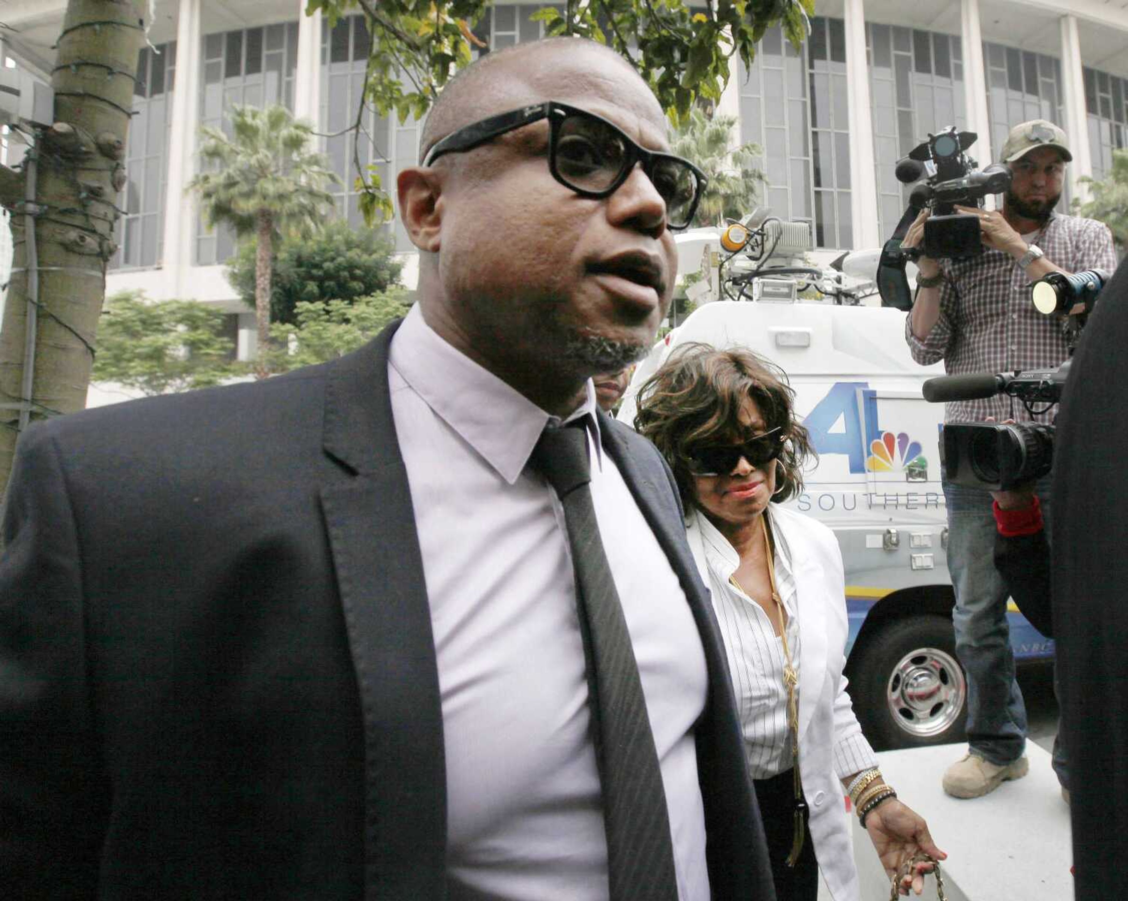 Randy Jackson and Rebbie Jackson, background right, brother and sister of late pop star Michael Jackson, arrive at a courthouse for Katherine Jackson&#8217;s lawsuit against concert giant AEG Live on Monday in Los Angeles. (Nick Ut ~ Associated Press)