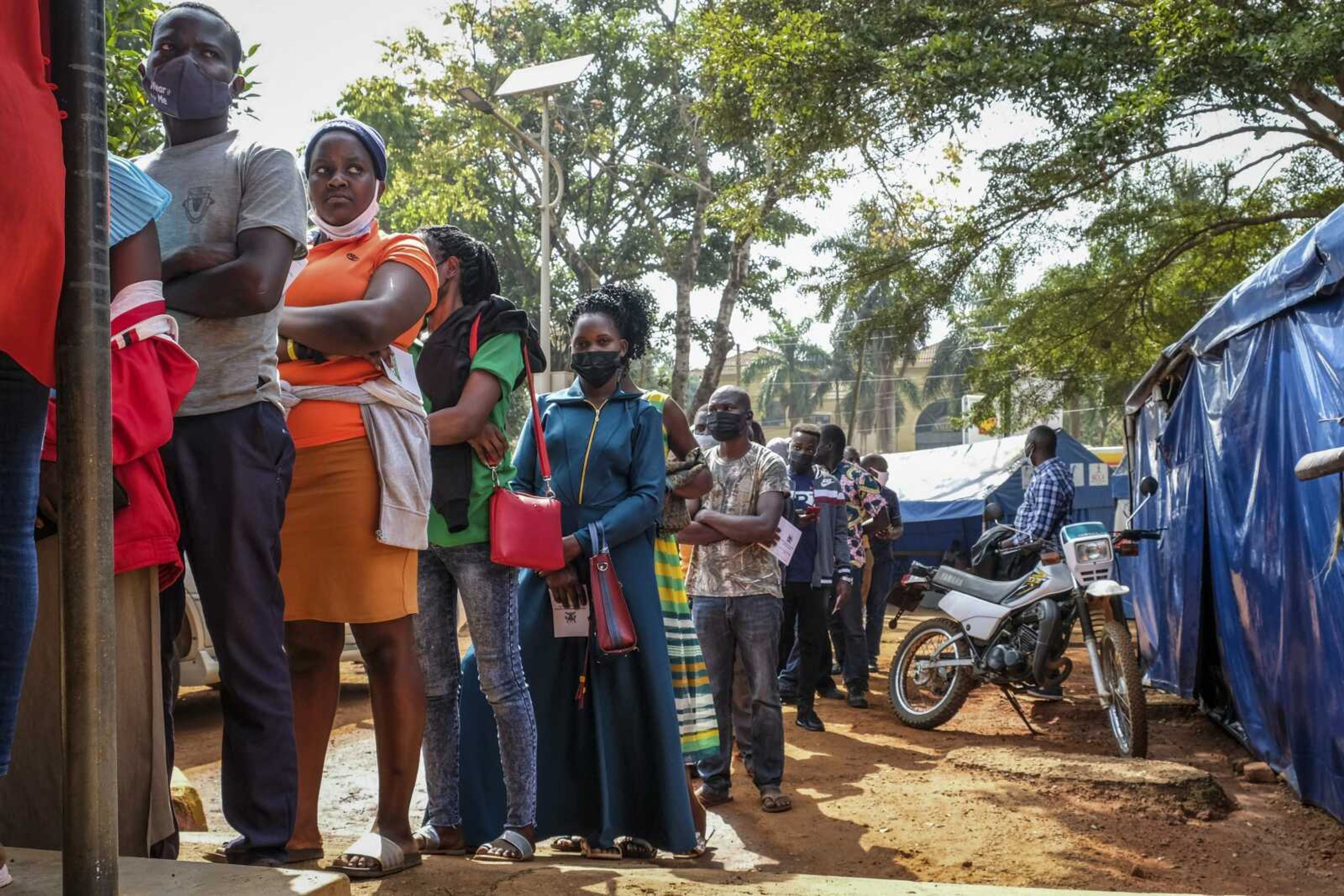 Ugandans queue to receive Pfizer coronavirus vaccinations Feb. 8 at the Kiswa Health Centre III in the Bugolobi neighborhood of Kampala, Uganda. In the latest Senate package targeted at stopping the coronavirus, U.S. lawmakers dropped nearly all funding for curbing the virus beyond its borders, in a move many health experts describe as dangerously short-sighted.