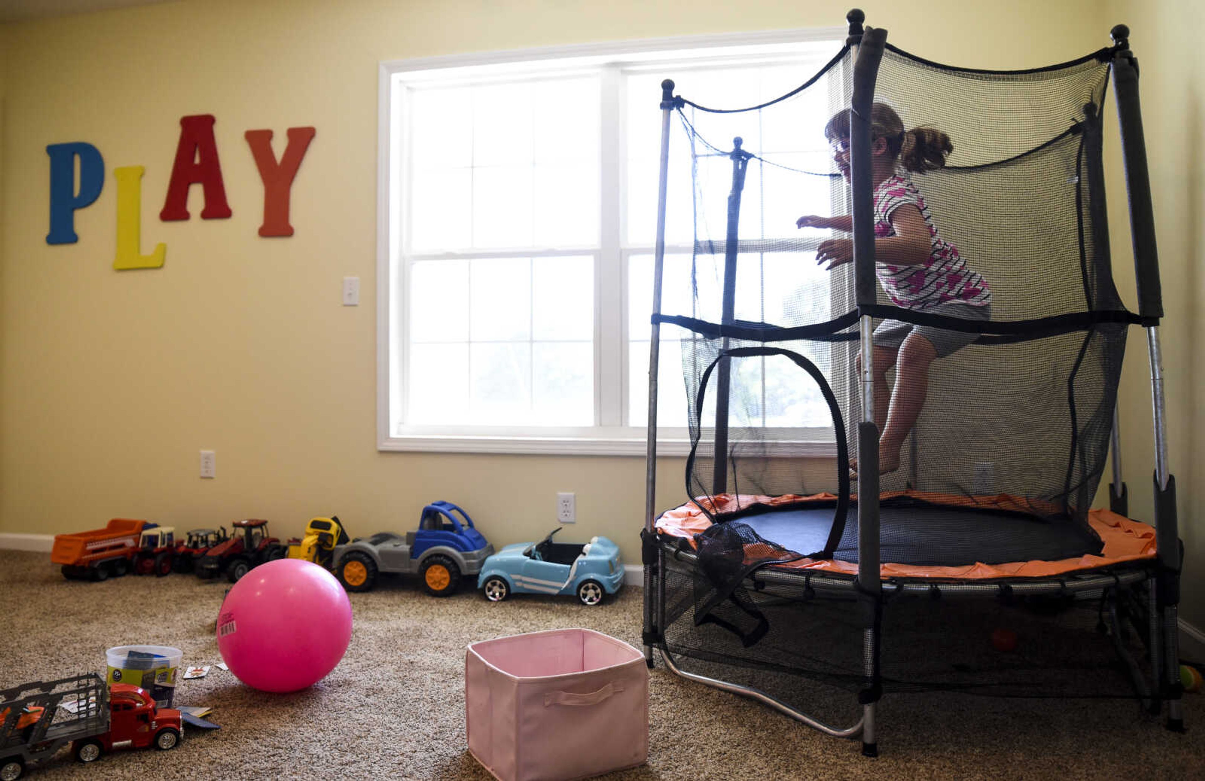 Lindyn Davenport, 6, jumps on a trampoline in her playroom at her home Sunday, June 3, 2018 in Sedgewickville.