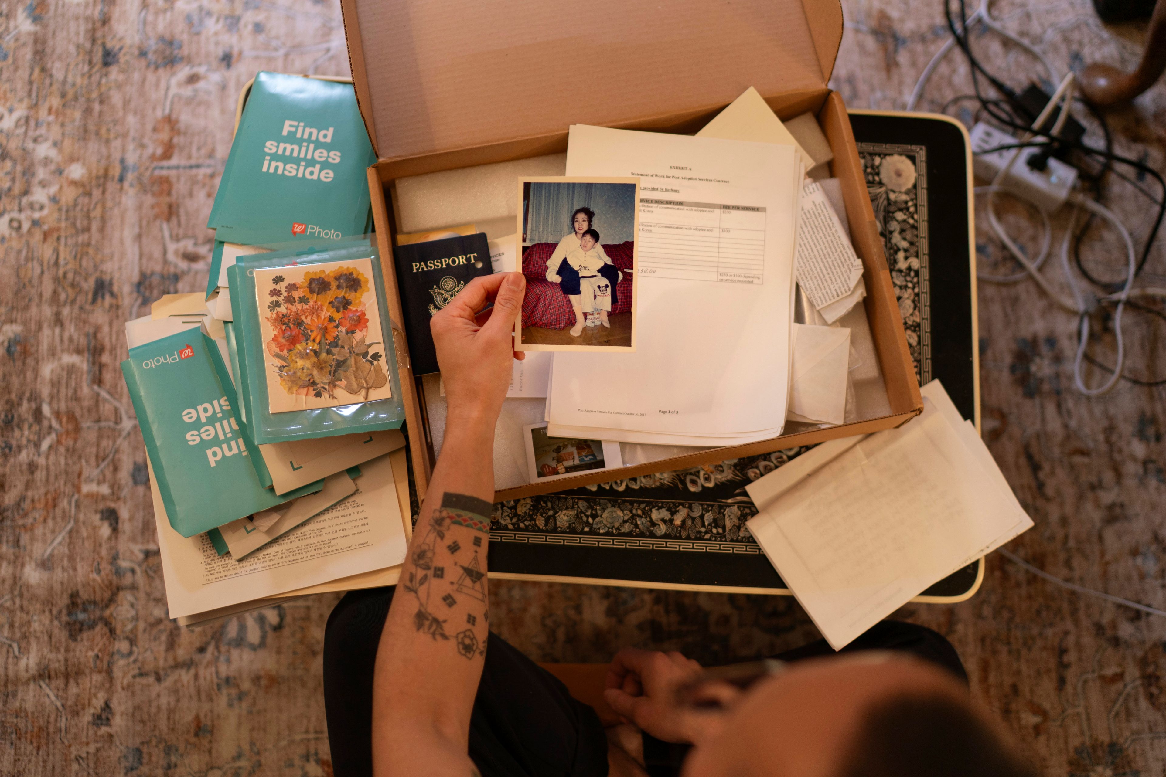 Robert Calabretta holds a picture of his biological mother and brother while sifting through family mementos at his apartment, Thursday, Feb. 15, 2024, in New York. After Calabretta was adopted as a baby to an American family, hospital officials told his mother to assume he had died. (AP Photo/David Goldman)