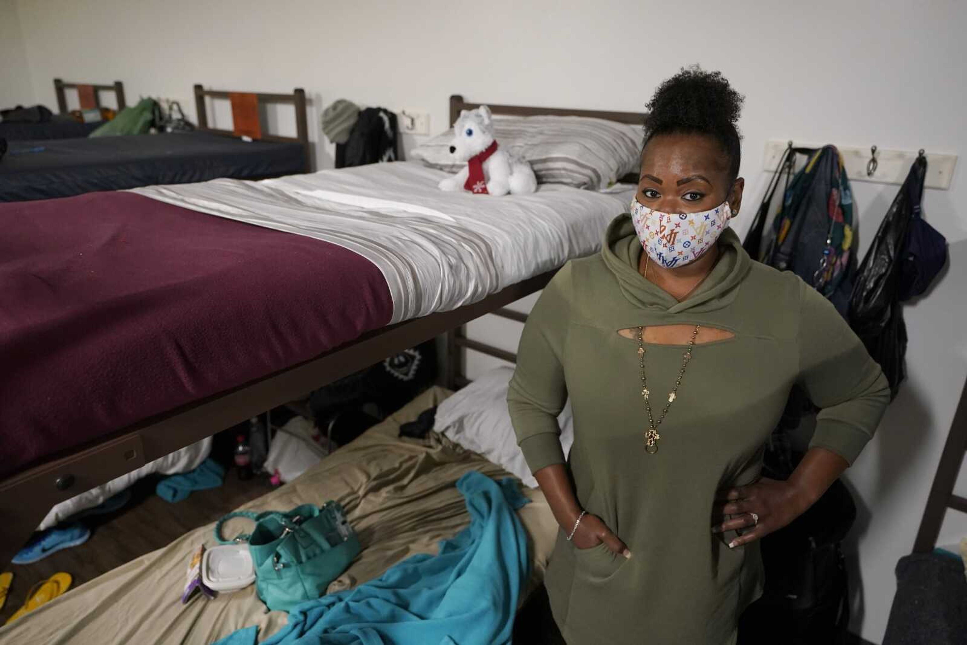 Cidney Oliver poses for a photo Wednesday by the bunk she sleeps on at a YWCA shelter for women lacking housing in Seattle. Earlier in the day, Oliver received the first dose of the Moderna COVID-19 vaccine at a clinic staffed by workers from Harborview Medical Center at the shelter. "It was important for me to protect myself and the health and welfare of others," Oliver said.