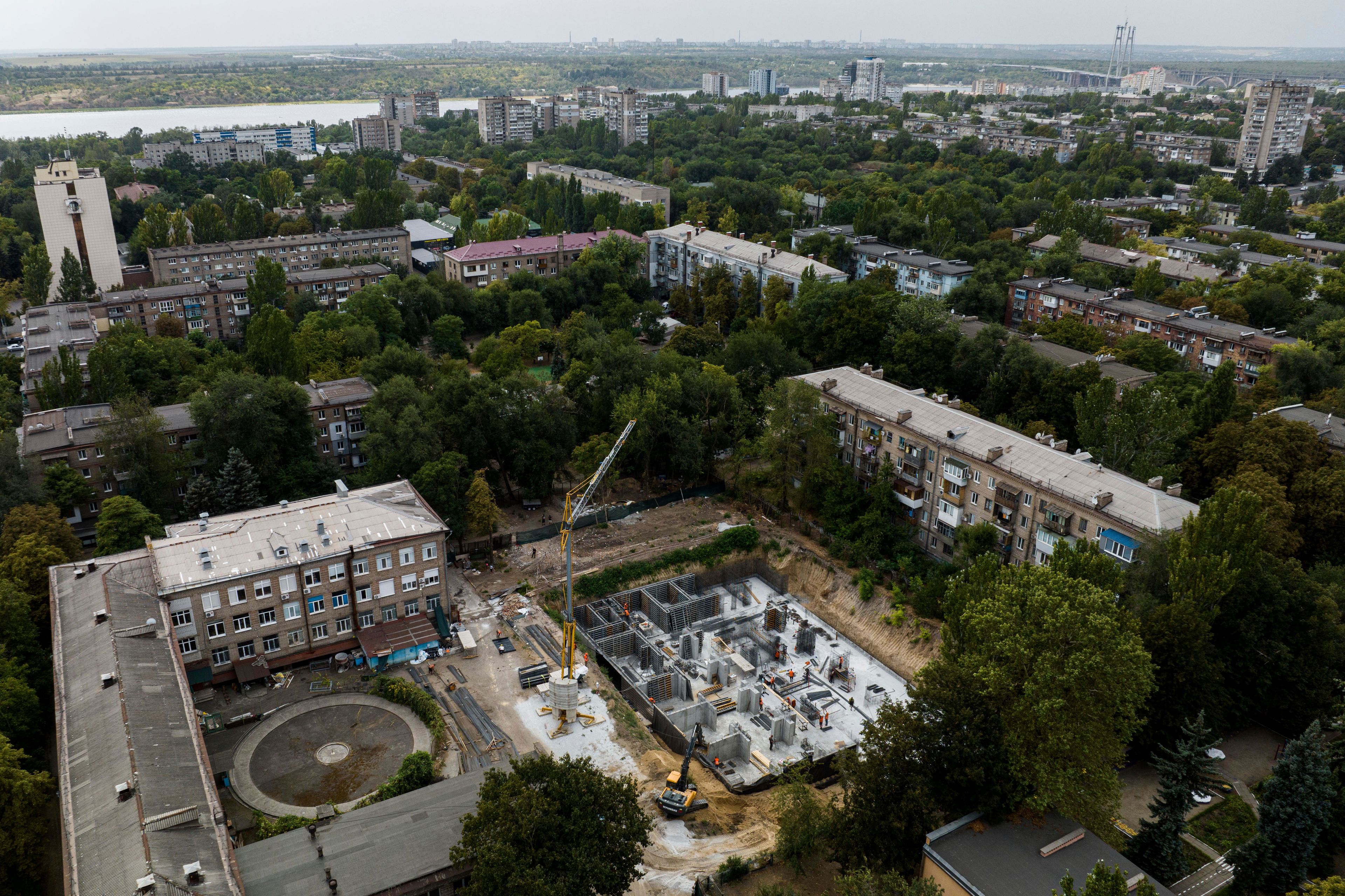 Construction workers dig out an underground school at Gymnasium No. 71 in Zaporizhzhia, Ukraine, Aug. 30, 2024, one of a dozen planned for the city and designed to be radiation- and bomb-proof. (AP Photo/Evgeniy Maloletka)