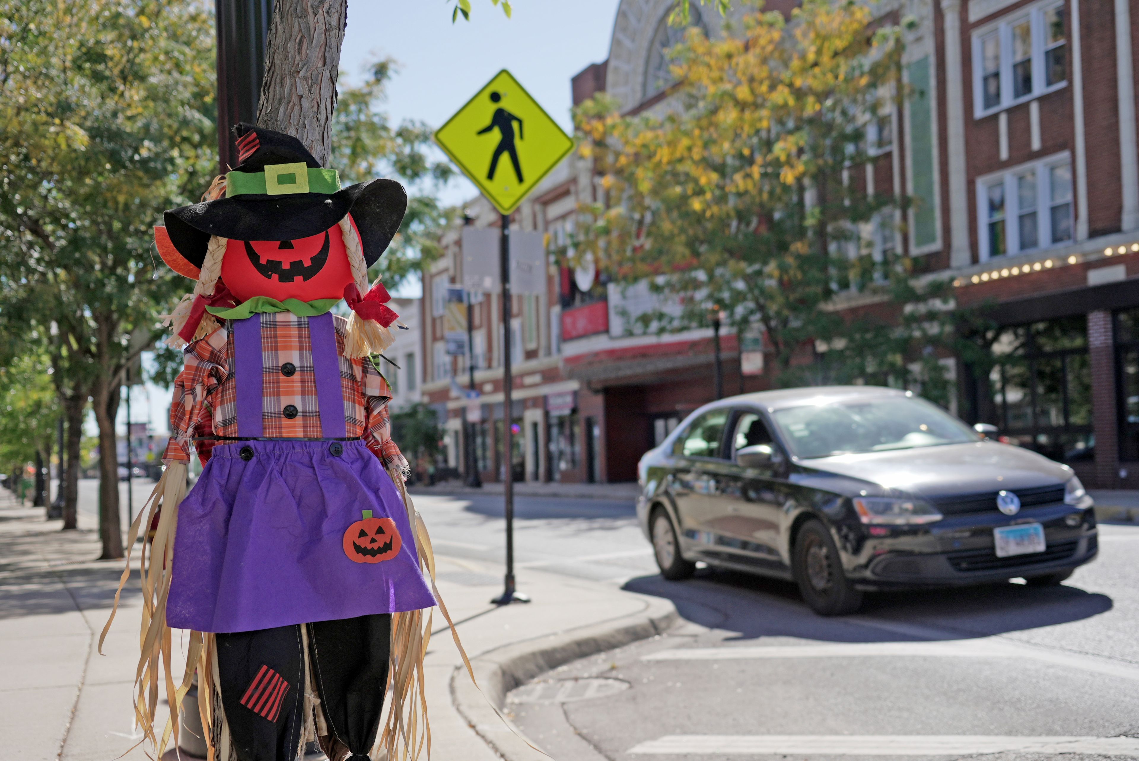 A car drives through a crosswalk near some Halloween decorations in Chicago on Oct. 8, 2024. (AP Photo/Laura Bargfeld)