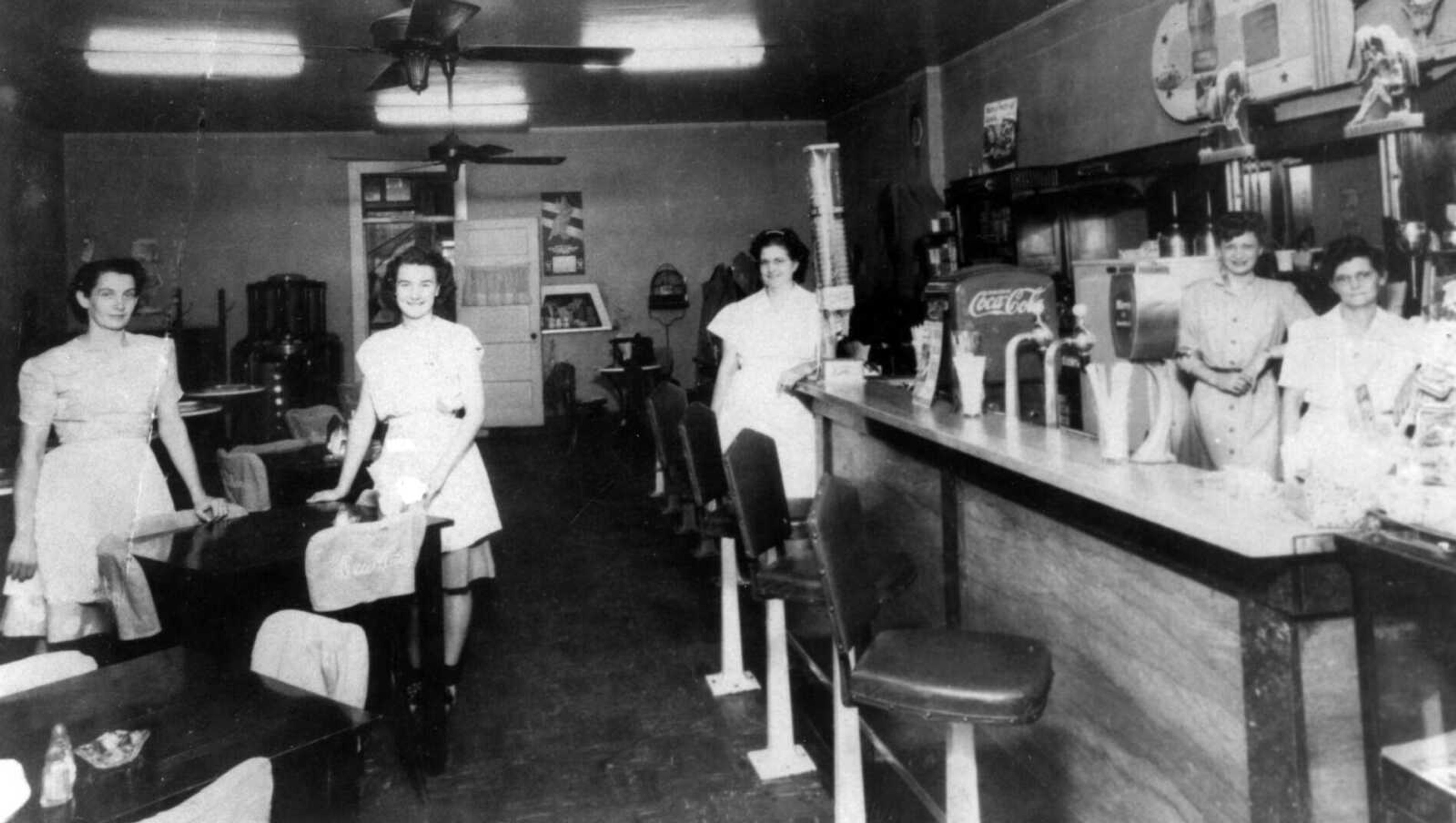 Homer and Madge Boswell, shown at far right, operated the Dew Drop In on North Main Street. At left are Sue Friese and Cherry Hopkins. 