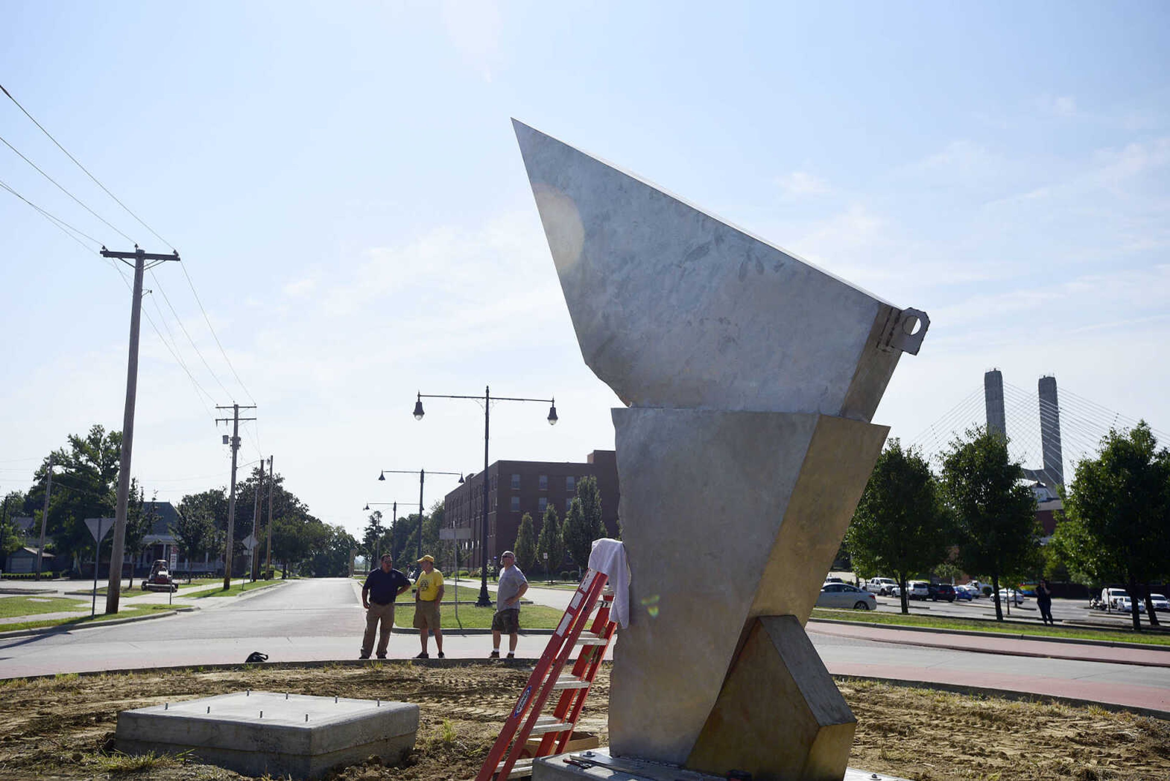 One piece of Chris Wubbena's sculpture "Commence" stands alone before the other piece before the other section is installed in the Fountain Street roundabout on Monday, July 24, 2017, near the River Campus in Cape Girardeau.