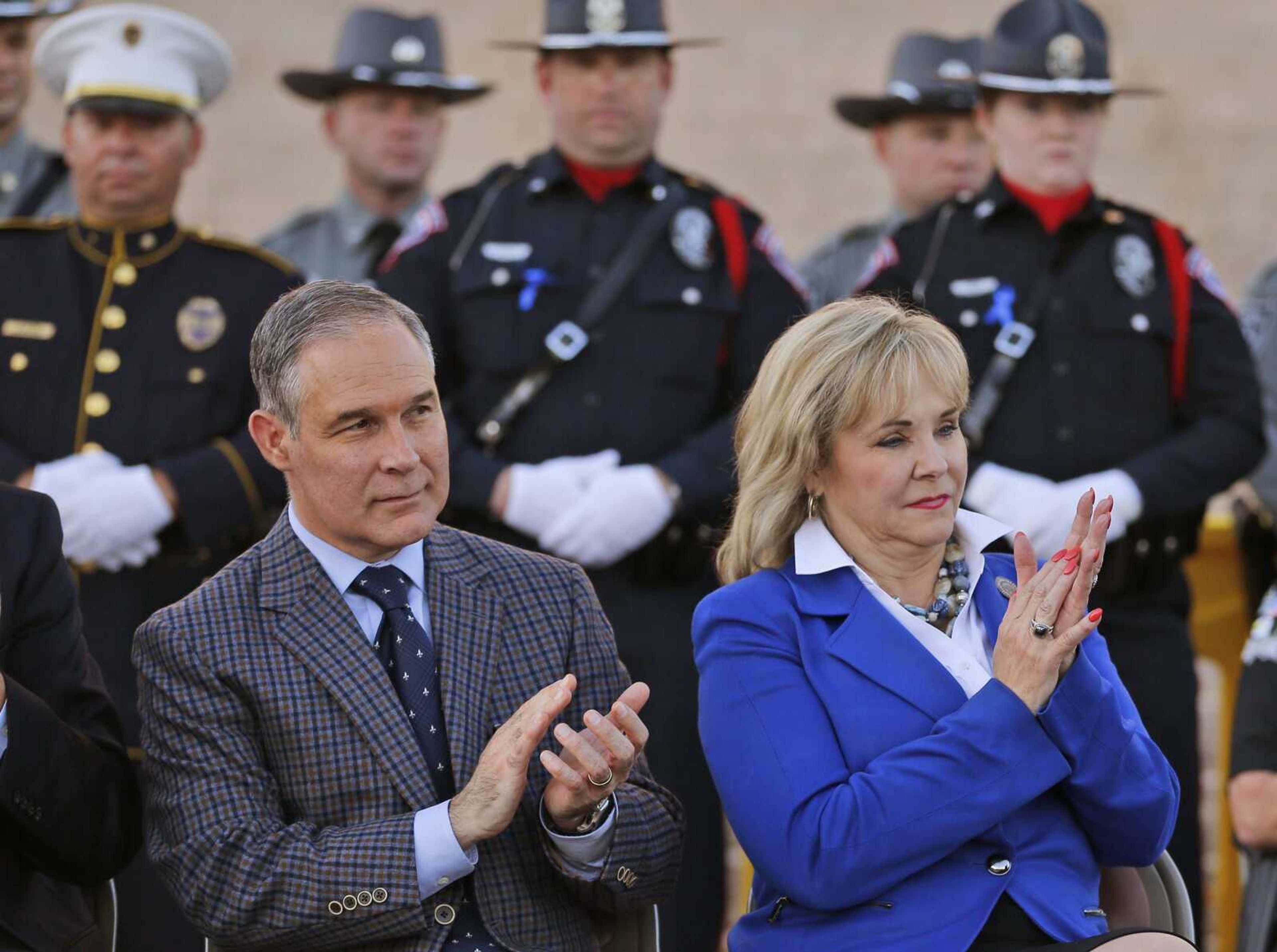 Scott Pruitt, Oklahoma attorney general, and Oklahoma Gov. Mary Fallin, right, applaud during a Back the Blue rally in October 2015 to support law enforcement. Pruitt is President-elect Donald Trump's nominee to lead the Environmental Protection Agency.