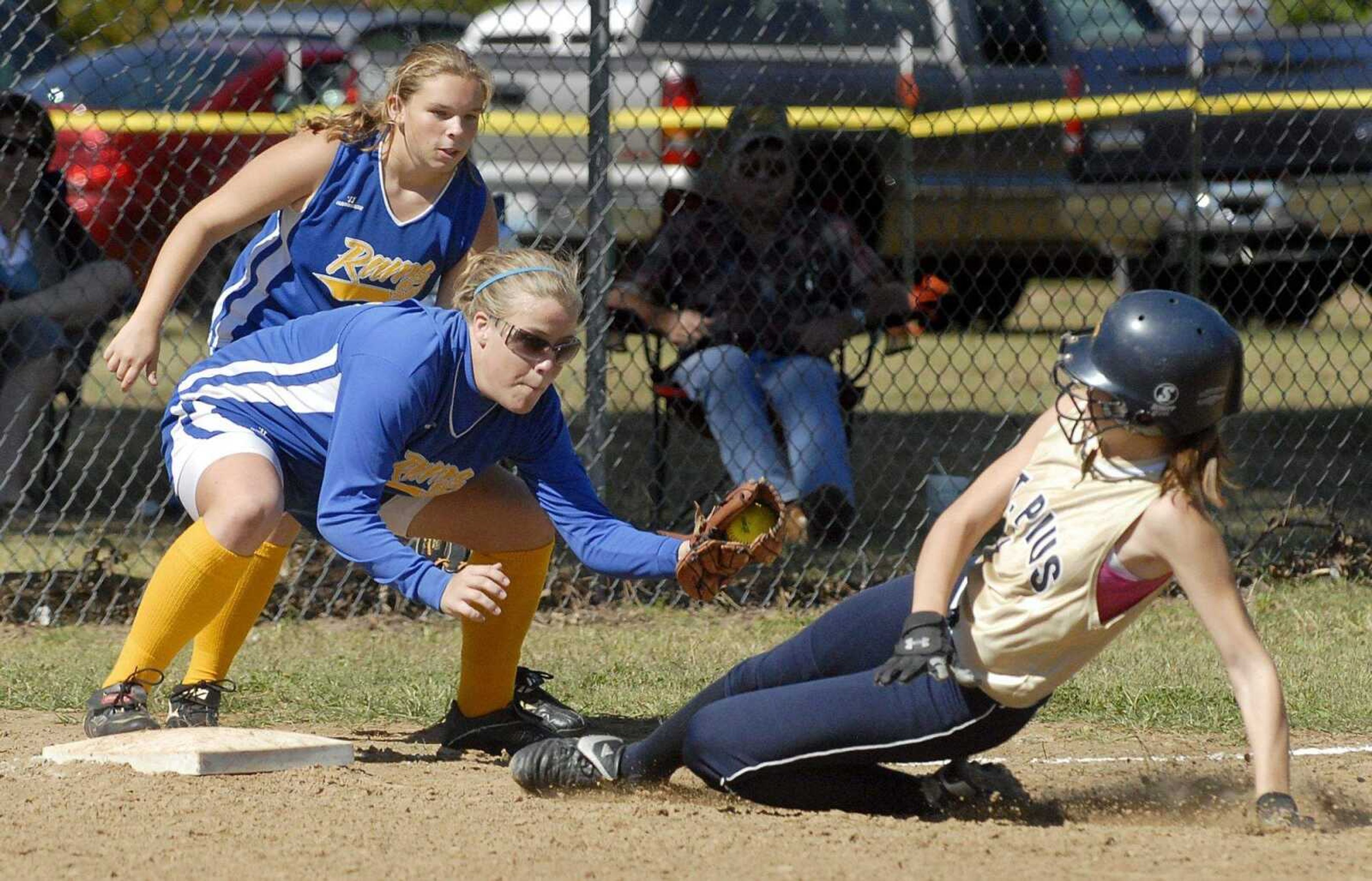 ELIZABETH DODD ~ edodd@semissourian.com
Scott City's Ashley Brant, left attempts to tag out St. Pius' Melissa Collins in the fifth inning in a 2-0 Scott City victory in the District Tournament at Kelly Thursday.