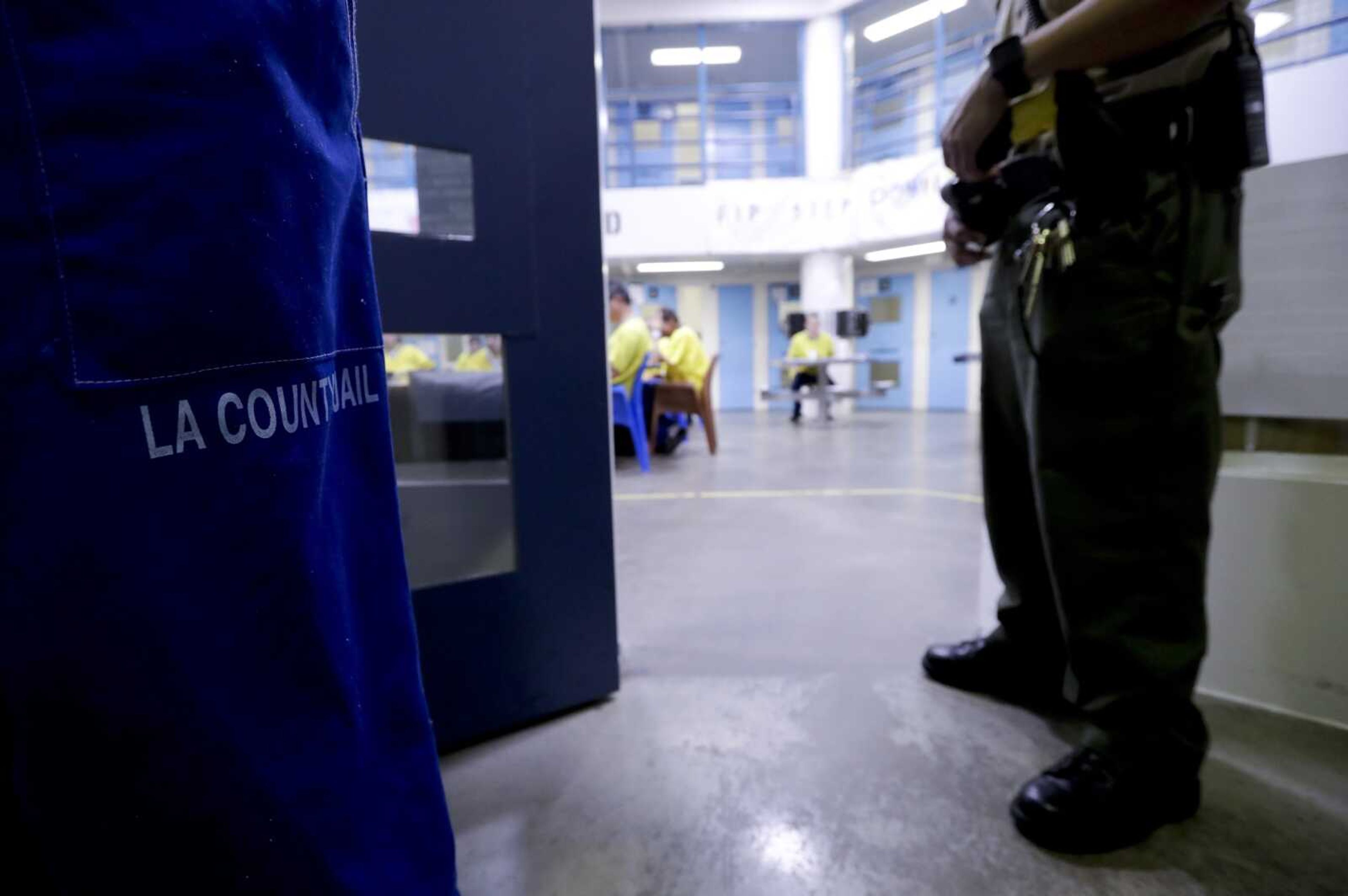 FILE - A sheriff's officer stands guard over inmates at the Twin Towers Correctional Facility on April 27, 2017, in Los Angeles.