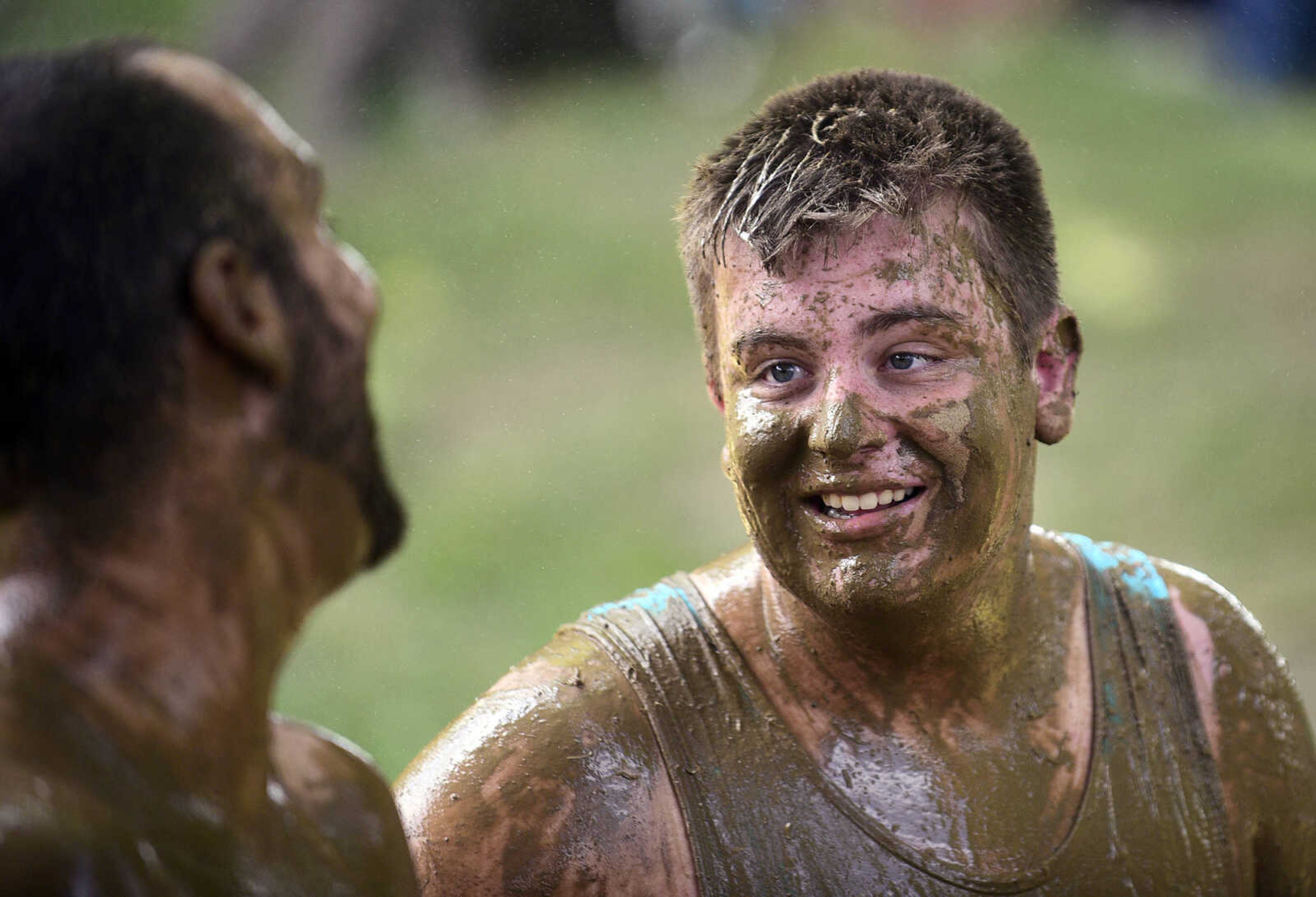 Mud covers team members as they play mud volleyball during the Fourth of July celebration on Tuesday at Jackson City Park.