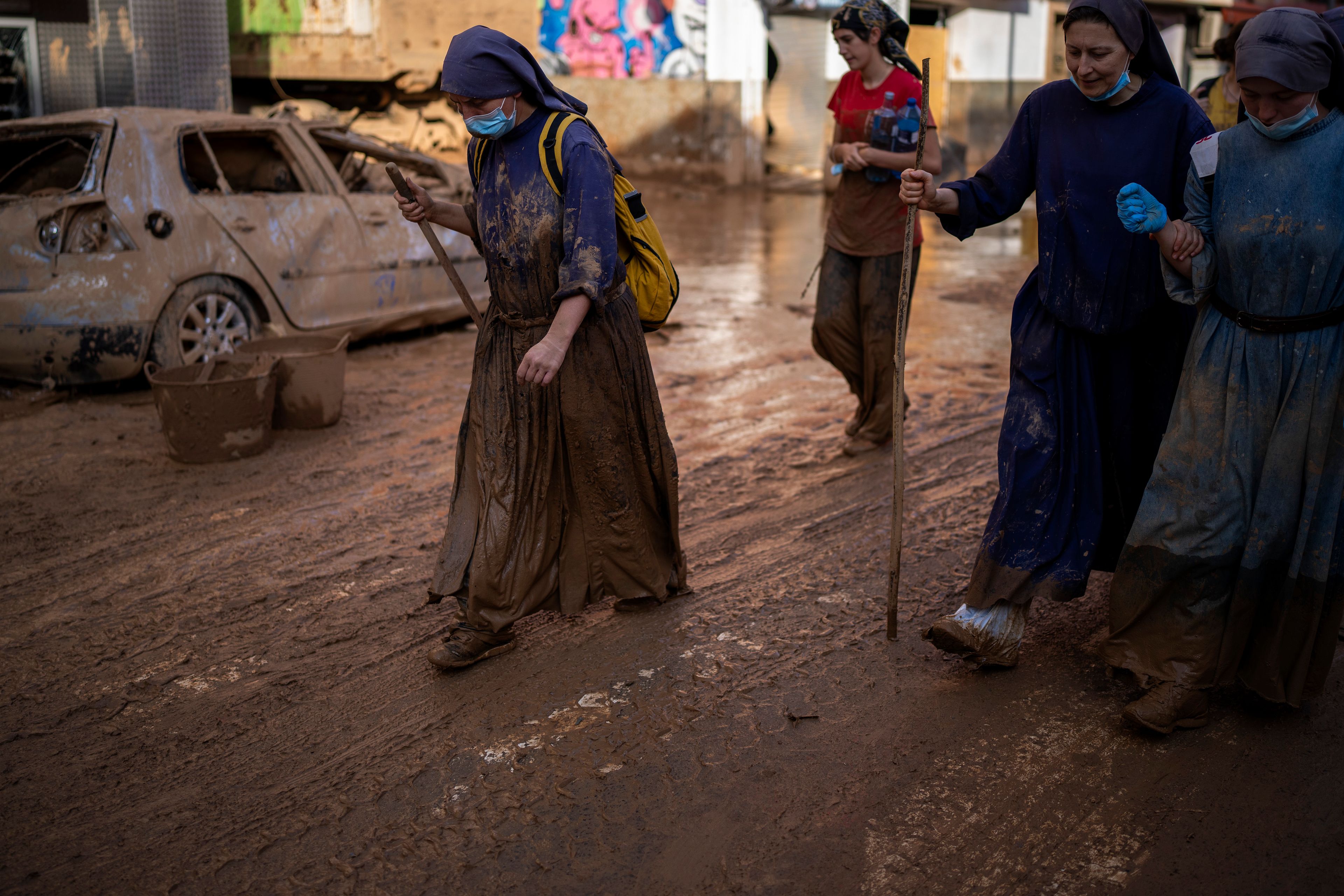 Sister Kelly walks after working as volunteer cleaning houses affected by floods in Paiporta, Valencia, Spain, Tuesday, Nov. 5, 2024. (AP Photo/Emilio Morenatti)