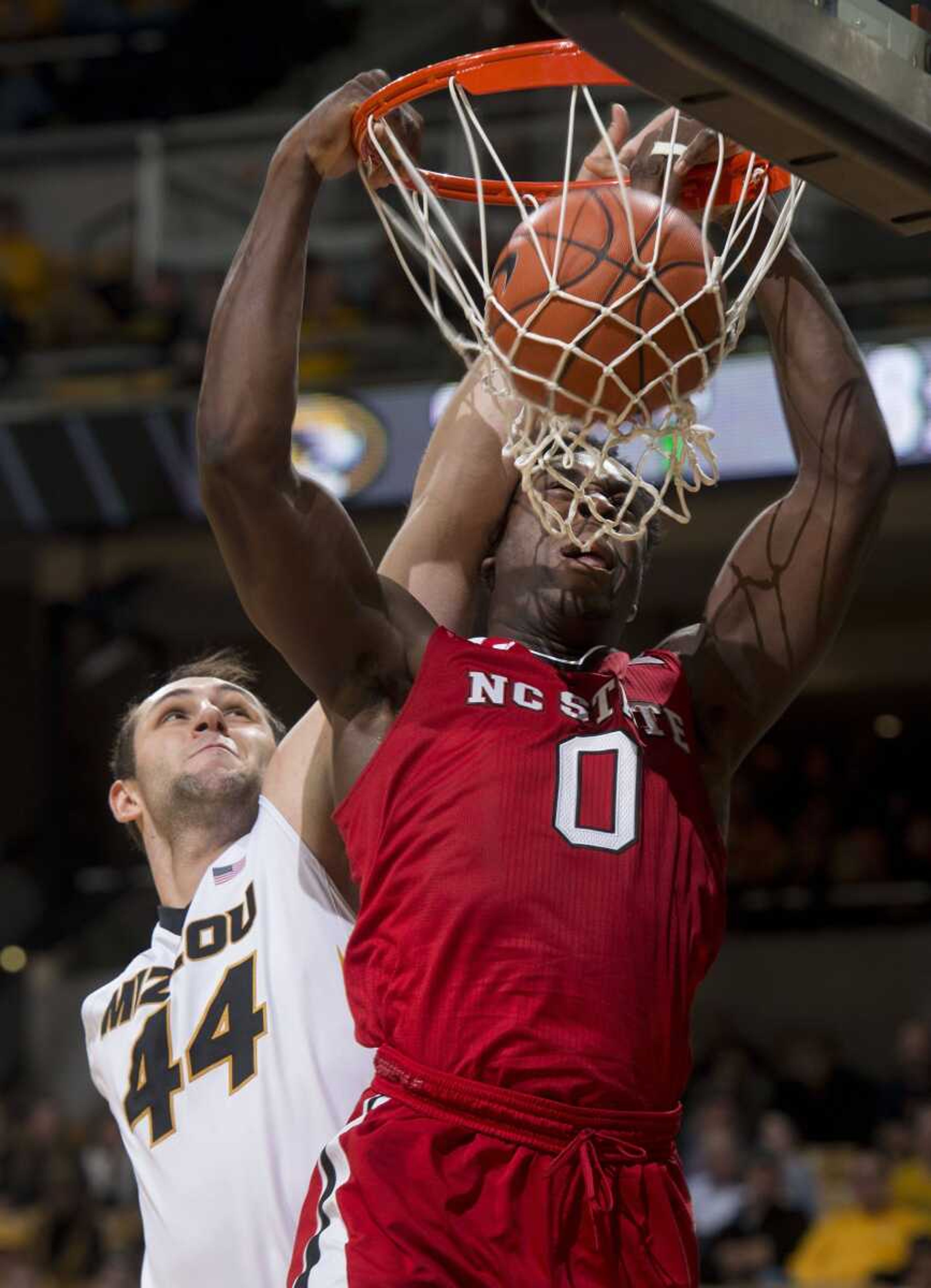 North Carolina State's Abdul-Malik Abu, right, is fouled by Missouri's Ryan Rosburg, left, as he dunks during the second half of Saturday's game in Columbia, Missouri. North Carolina State won 73-59. (L.G. Patterson ~ Associated Press)