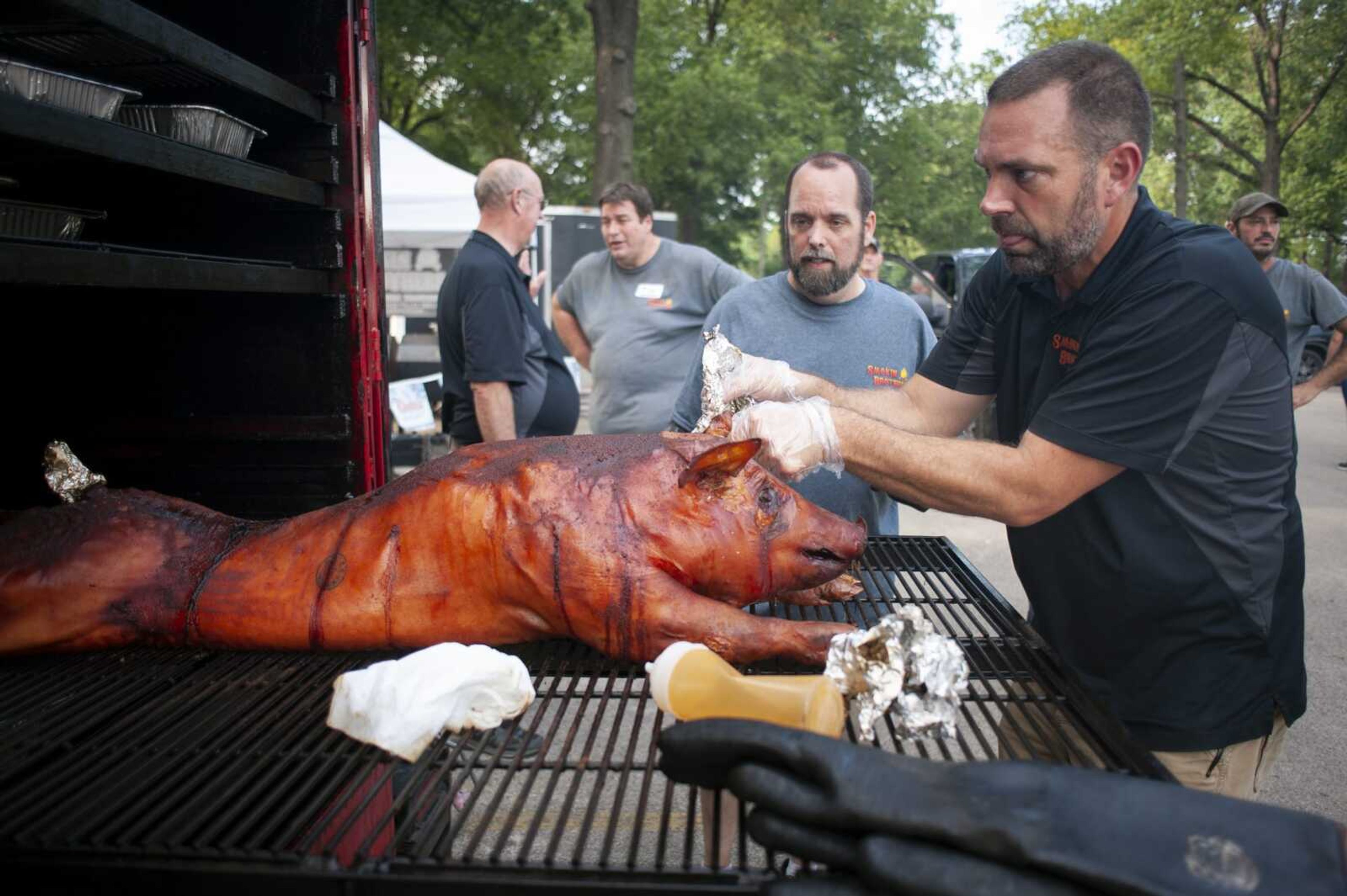 Smokin Brothers co-owner Ryan Eftink of Cape Girardeau, foreground, is seen during a barbecue event Aug. 18, 2019, in Cape Girardeau. Eftink is organizer of When Pigs Fly Indoor BBQ Bash on Saturday, Jan. 14, at the Show Me Center.