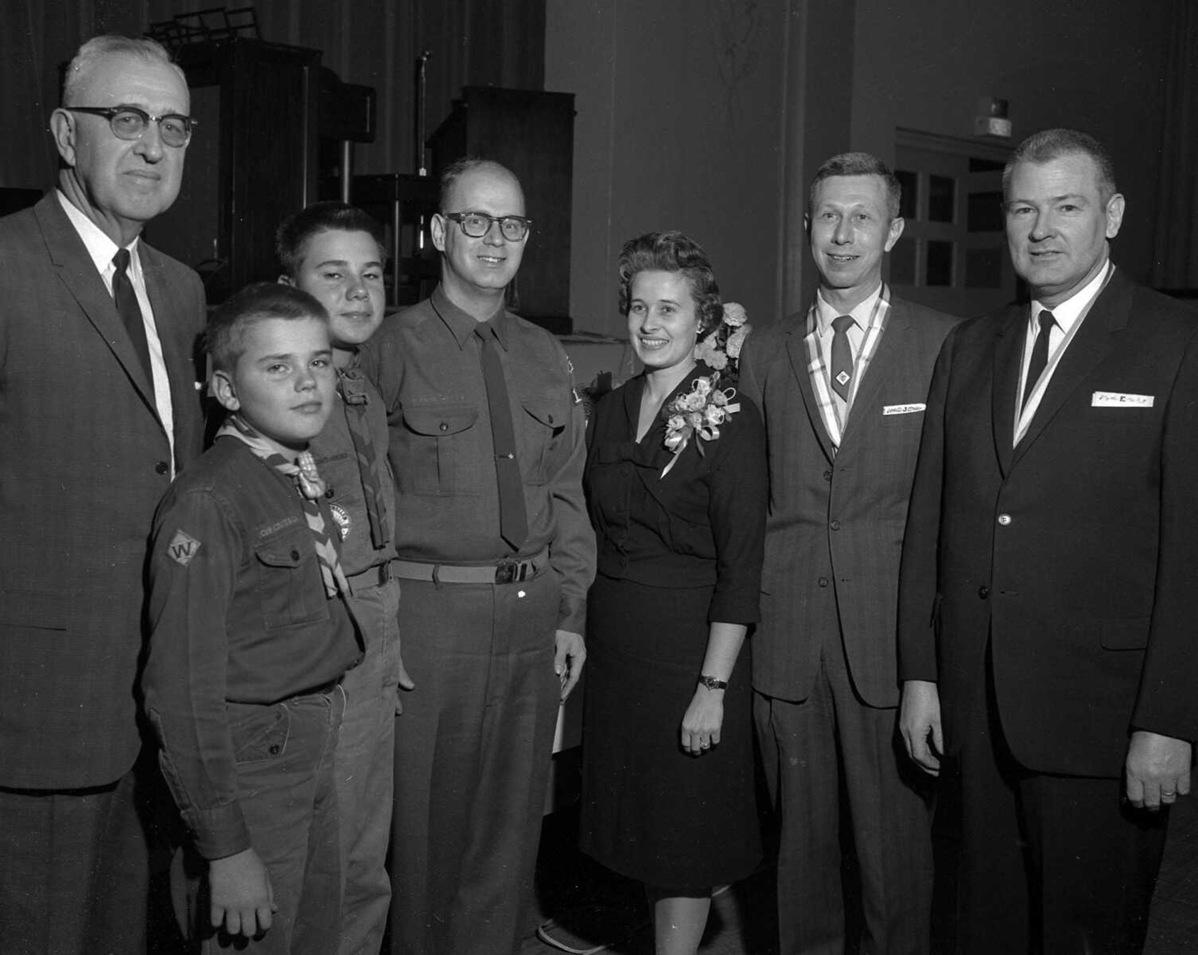 Ron Grebing wrote: "The lady and the man to her left are Hertha and Joe Russell. From the looks of the ribbon around Joe's neck, it was when he received the Silver Beaver Award." Hertha Russell and Tony Smee supplied the date of publication for this photo, Dec 4, 1963. In it, Cape Girardeau attorney J.J. Russell received the Silver Beaver Award at the Shawnee District's annual dinner at the Arena: "From the left are Marshall Craig, who made the presentation; Gary and Eddie Van Weelden, members of Pack 16 and Troop 16; Larry Gray, scoutmaster, Troop 16; Mr. and Mrs. Russell, and Robert Eckelmann. Mr. Eckelman was Mr. Russell's scoutmaster, Mr. Russell was Mr. Gray's scoutmaster and Mr. Gray in turn in scoutmaster and club leader for the Van Weelden boys; this is a case of progressive scouting."