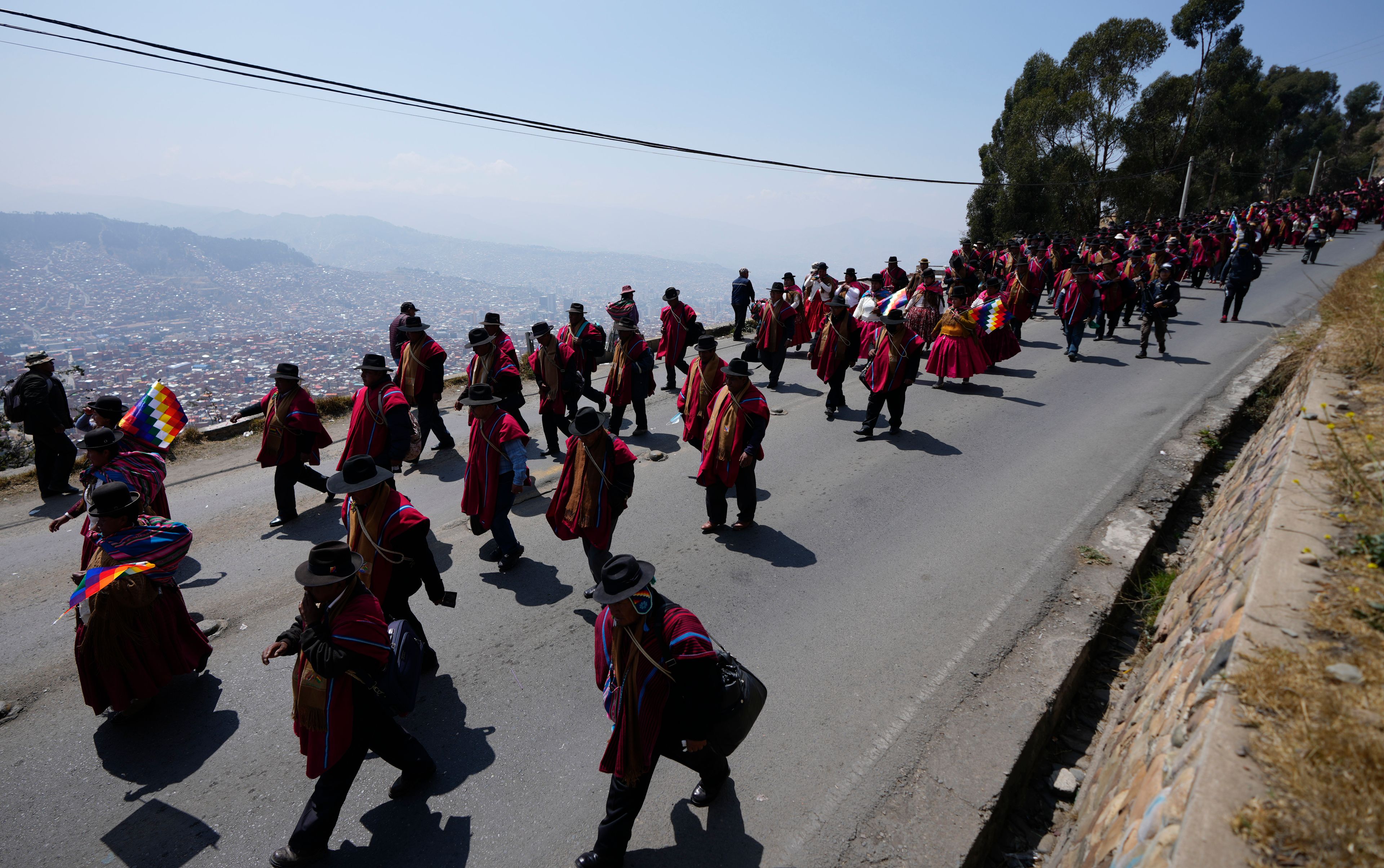 FILE - Farmers march to protest President Luis Arce's handling of the economy, in El Alto, Bolivia, Sept. 25, 2024. (AP Photo/Juan Karita, File)