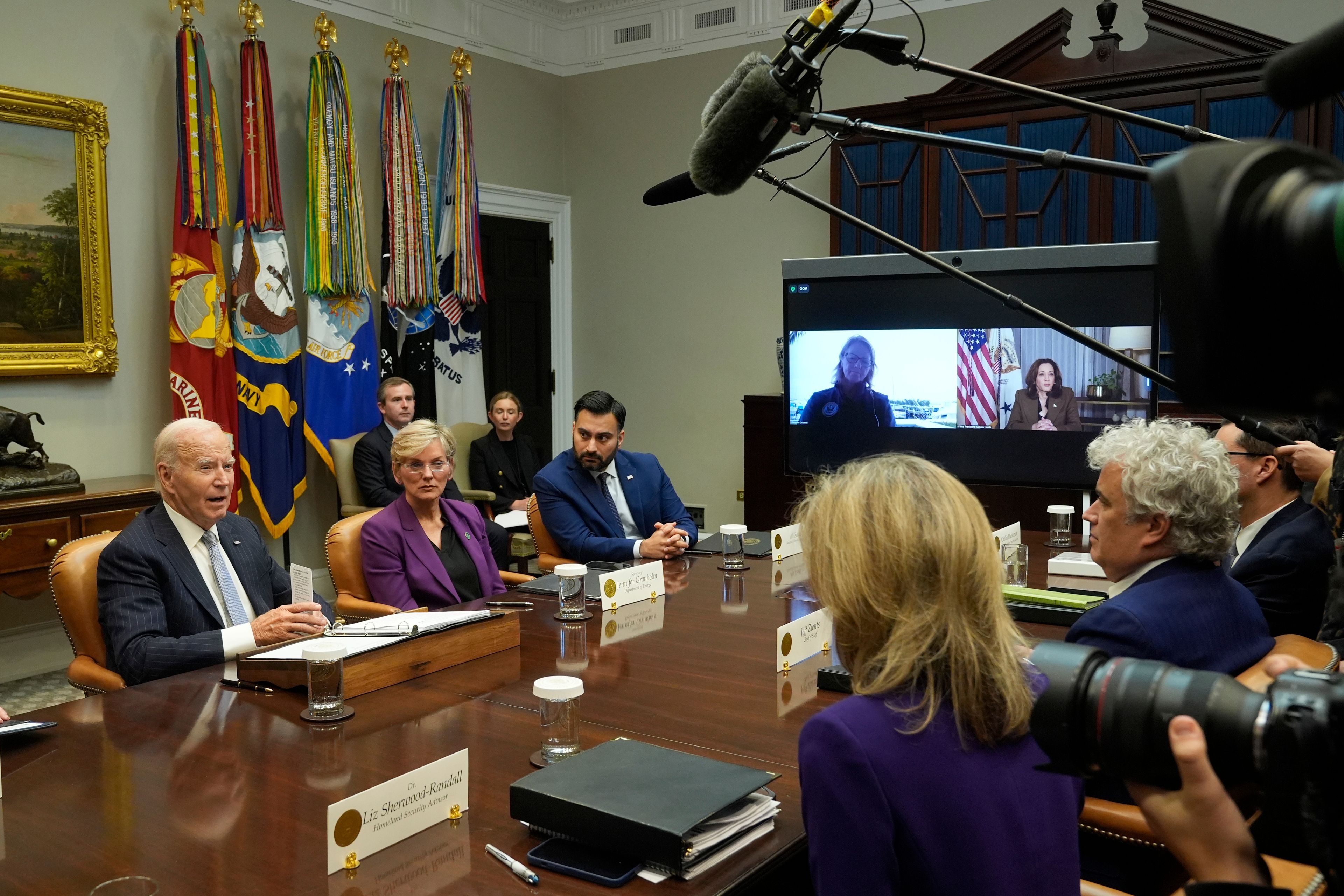 President Joe Biden, from left, joined by Energy Secretary Jennifer Granholm, White House climate adviser Ali Zaidi, and on screen from left, FEMA Administrator Deanne Criswell and Vice President Kamala Harris, speaks about the federal government's response to Hurricanes Milton and Helene, in the Roosevelt Room of the White House, Friday, Oct. 11, 2024, in Washington. Listening from right are White House chief of staff Jeff Zients and White House Homeland Security Advisor Liz Sherwood-Randall. (AP Photo/Manuel Balce Ceneta)