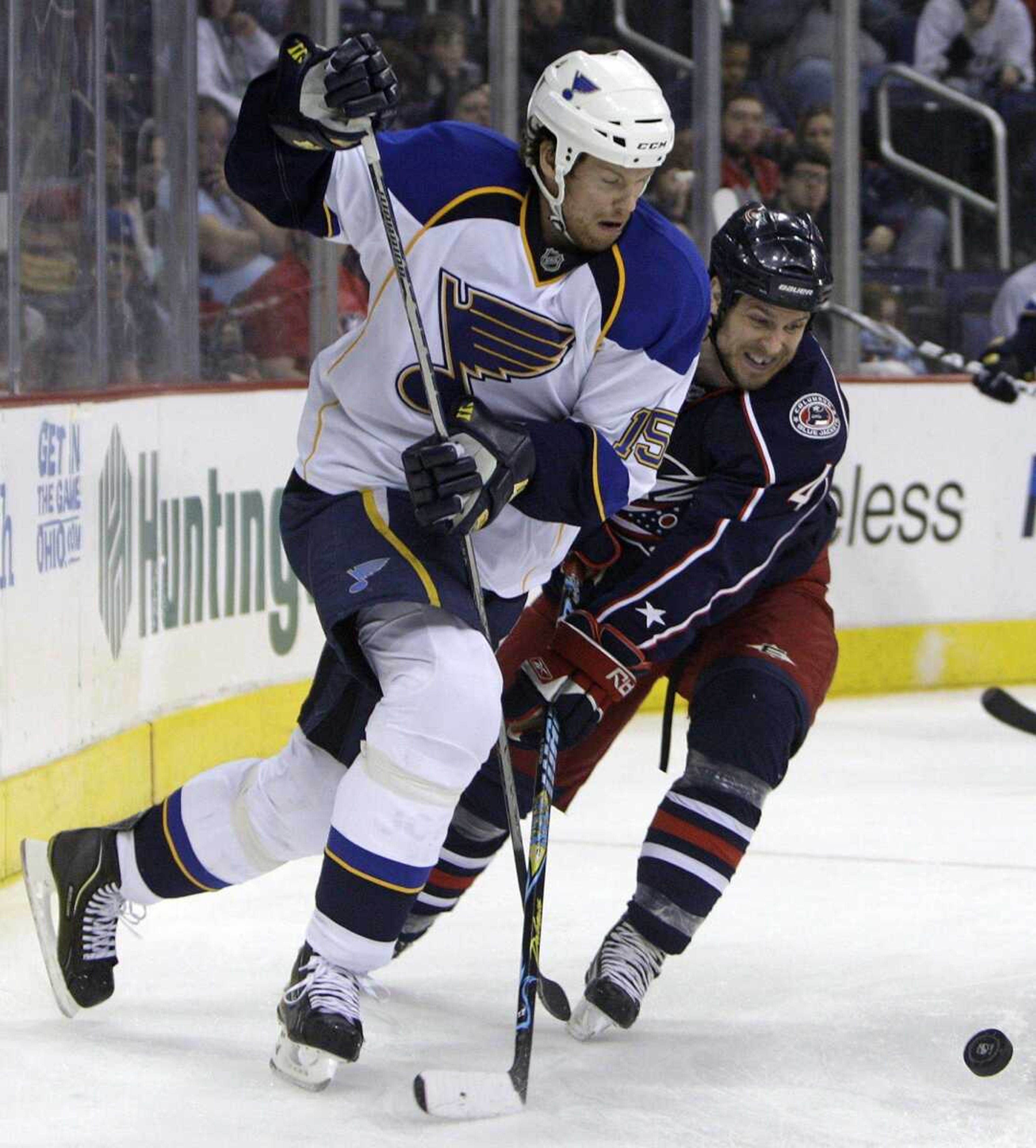 Blue Jackets defenseman Nathan Paetsch, right, and Blues forward Brad Winchester chase a loose puck during the third period of their game Saturday in Columbus, Ohio. (JAY LAPRETE ~ Associated Press)