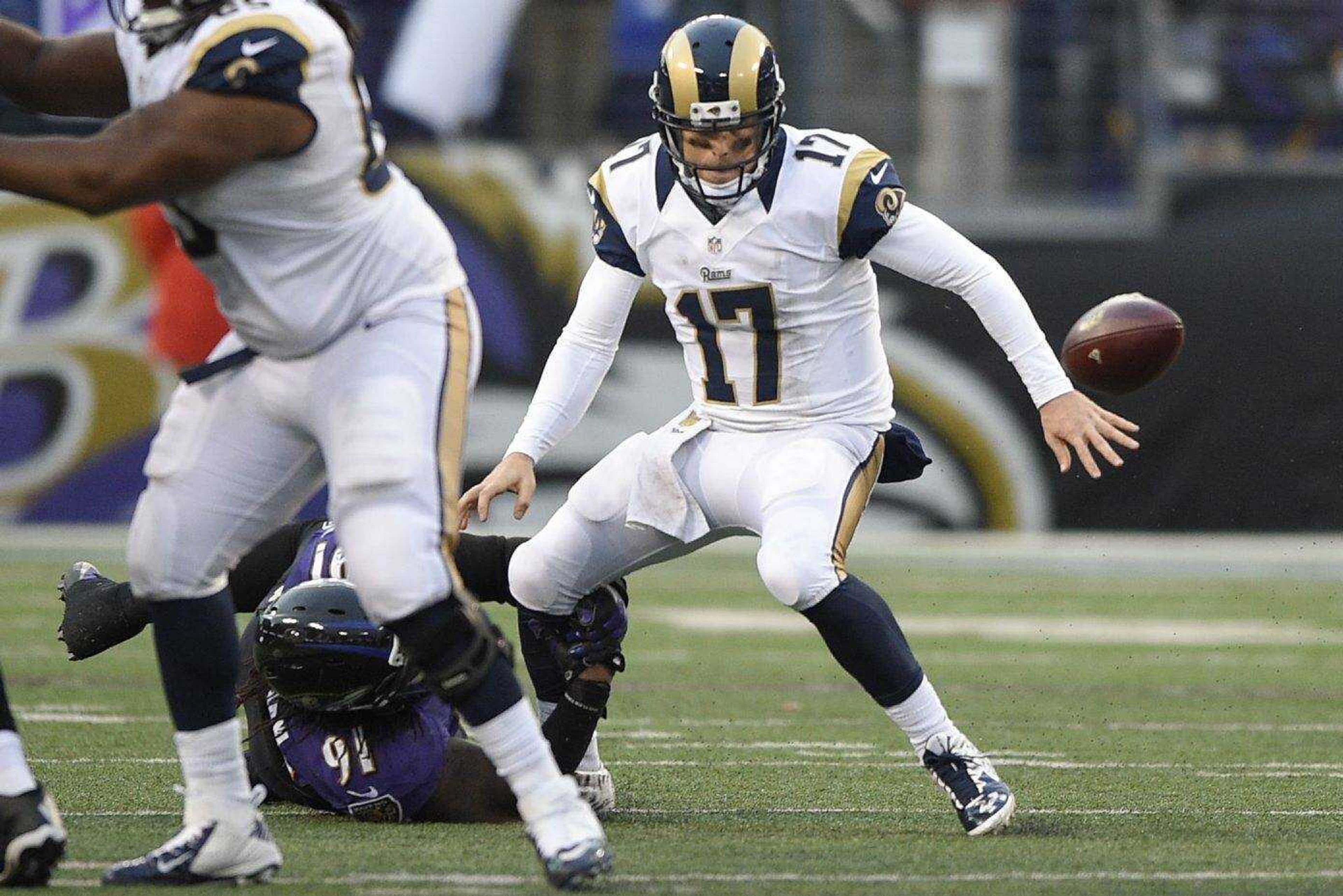 Rams quarterback Case Keenum fumbles the ball on a hit from Ravens outside linebacker Courtney Upshaw during the fourth quarter Sunday in Baltimore. The Ravens recovered the ball, which led to the game-winning field goal. (Nick Wass ~ Associated Press)