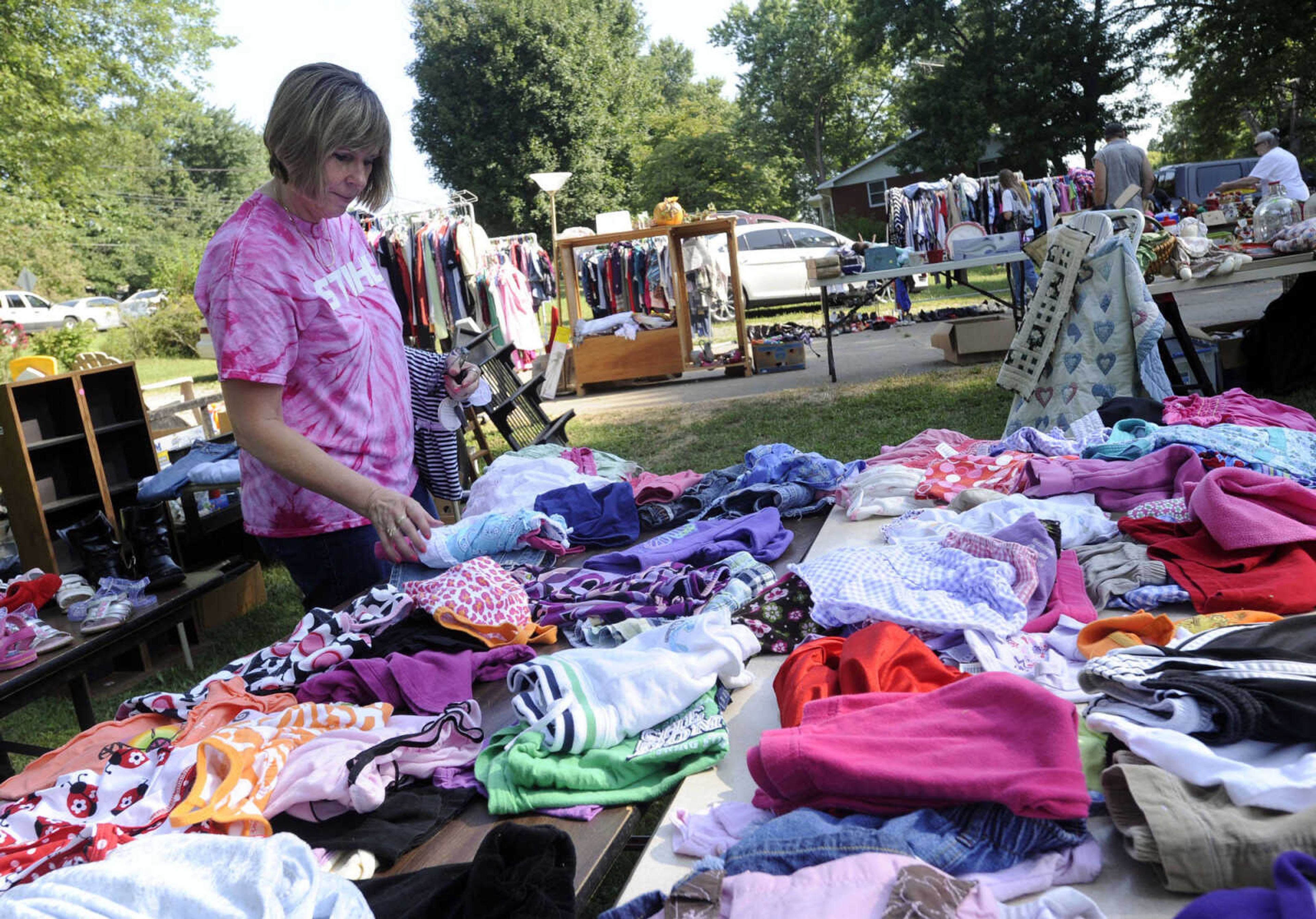 Donna VanGennip of Marble Hill, Mo. checks an array of clothing items offered during the Highway 61 Yard Sale Saturday, Aug. 31, 2013 in Jackson.