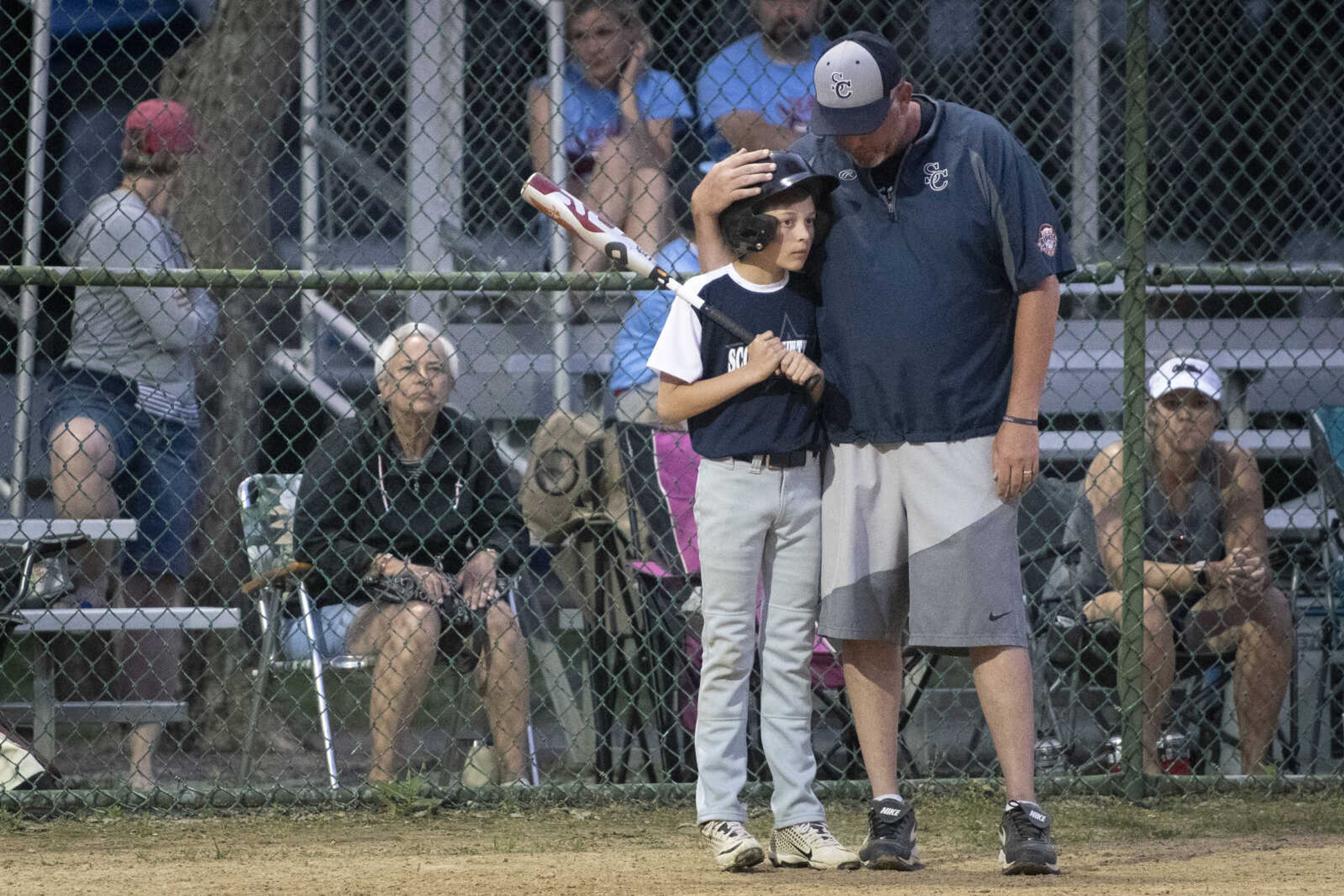 Aiden Wendel meets with Scott County All-Stars head coach Matt Asher during the team's 5-2 victory over the SEMO Cardinals in the championship game of the 2019 Kelso 11U Showdown on Sunday, June 2, 2019, in Kelso.