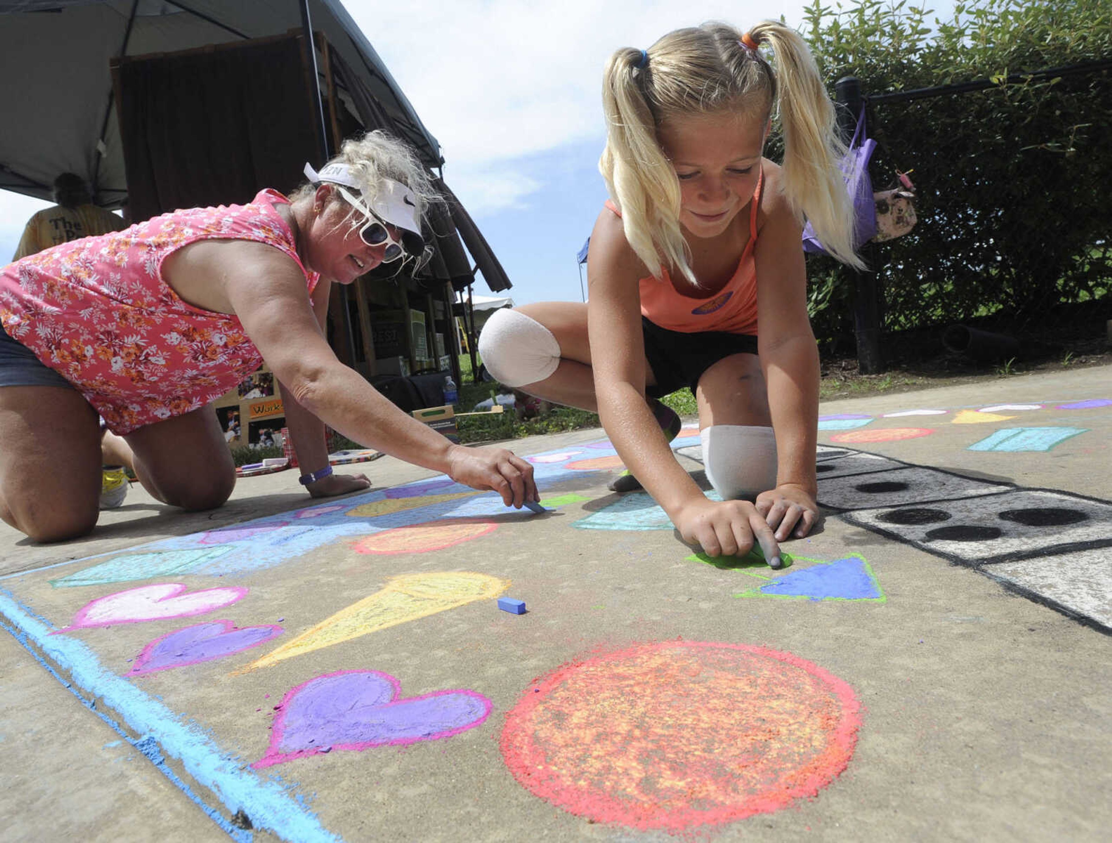 Julie Birk and her daughter, Amie Birk, work on their chalk art design on the Avenue of Art Saturday, June 21, 2014 at the River Campus Summer Arts Festival in Cape Girardeau.