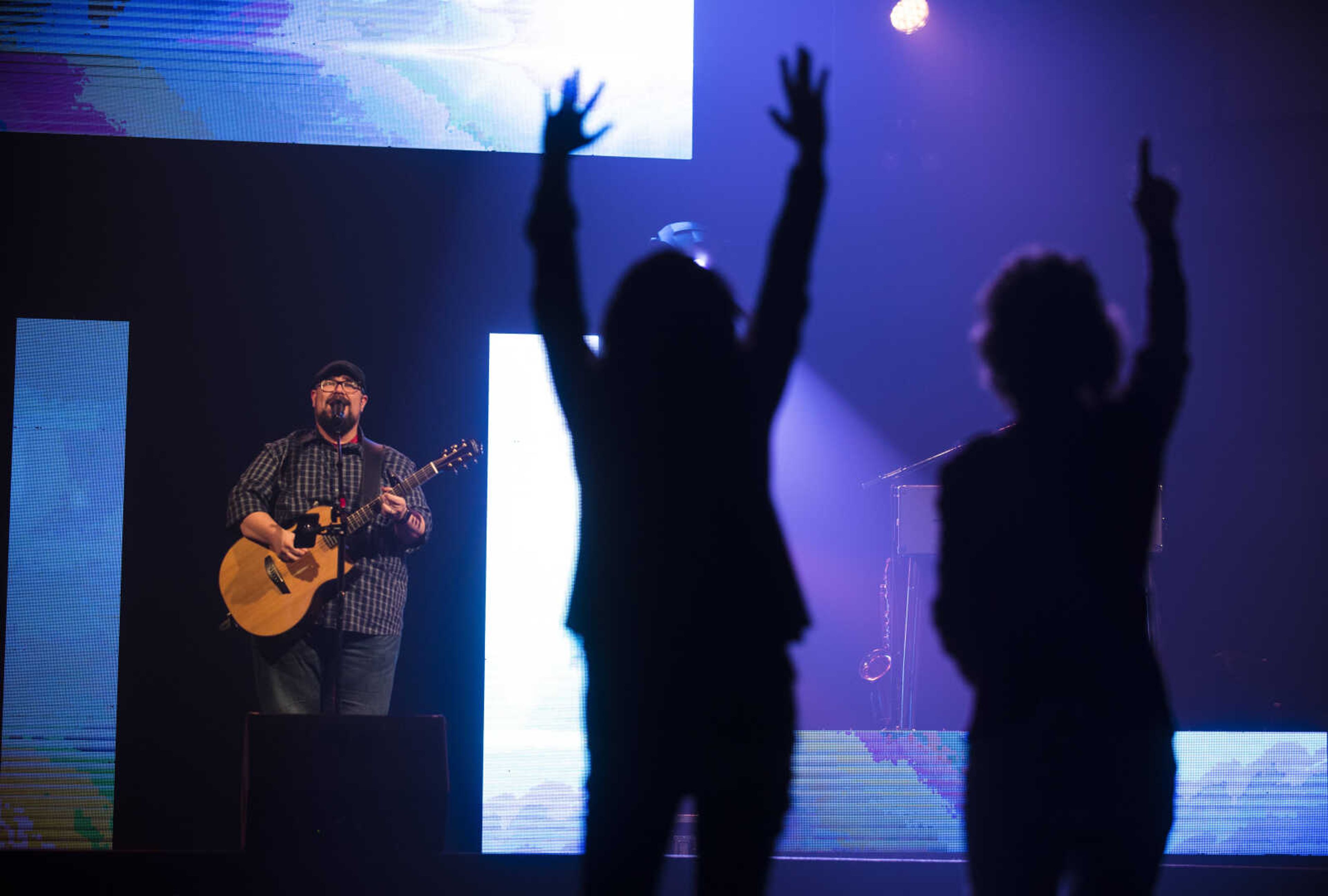 Tiffany Phillips, center, and Christy Walter dance in the aisle during a Big Daddy Weave concert Wednesday, March 14, 2018, at Cape Bible Chapel in Cape Girardeau.