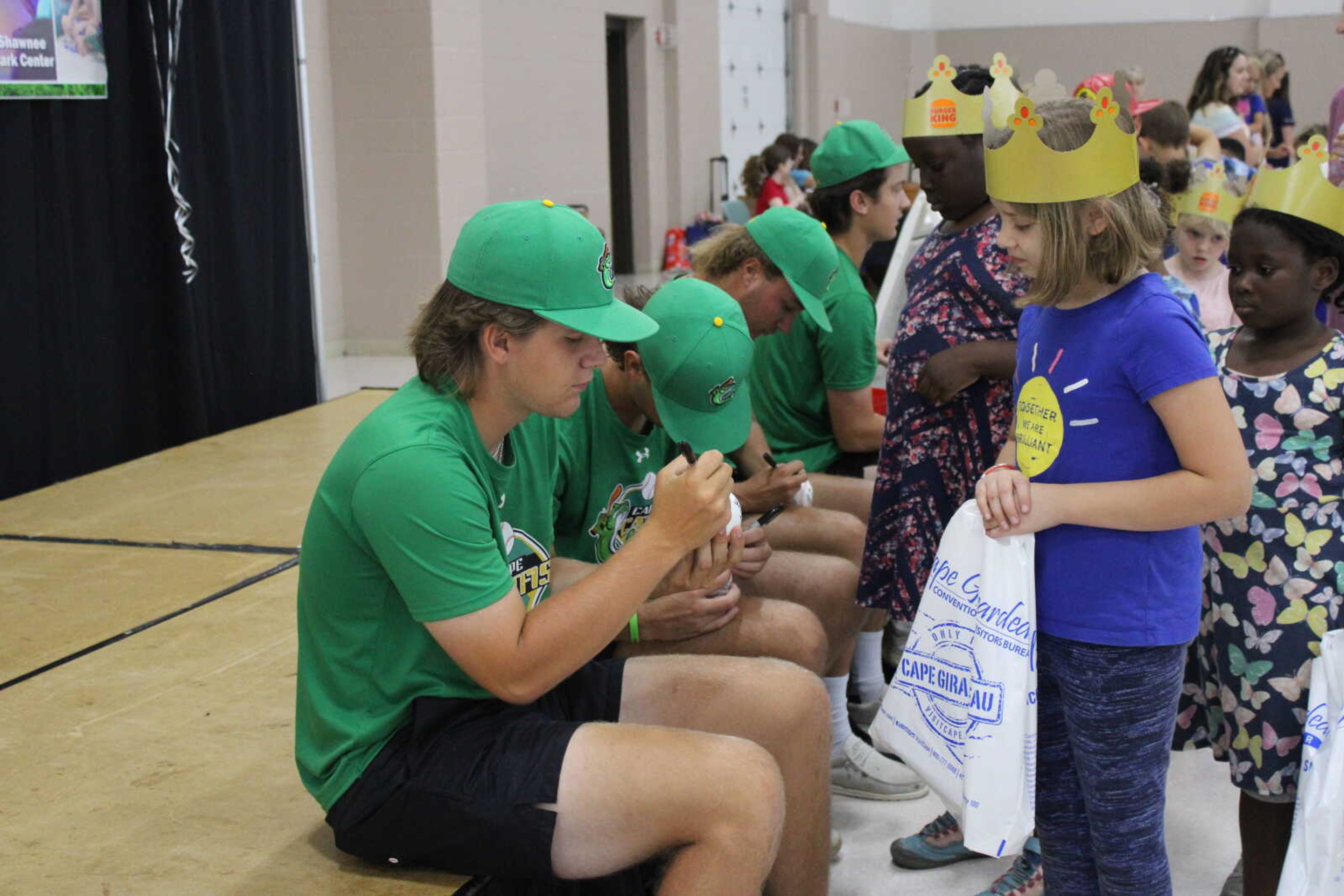 Cape Catfish players sign baseballs for those who attended the Parks and Rec day.