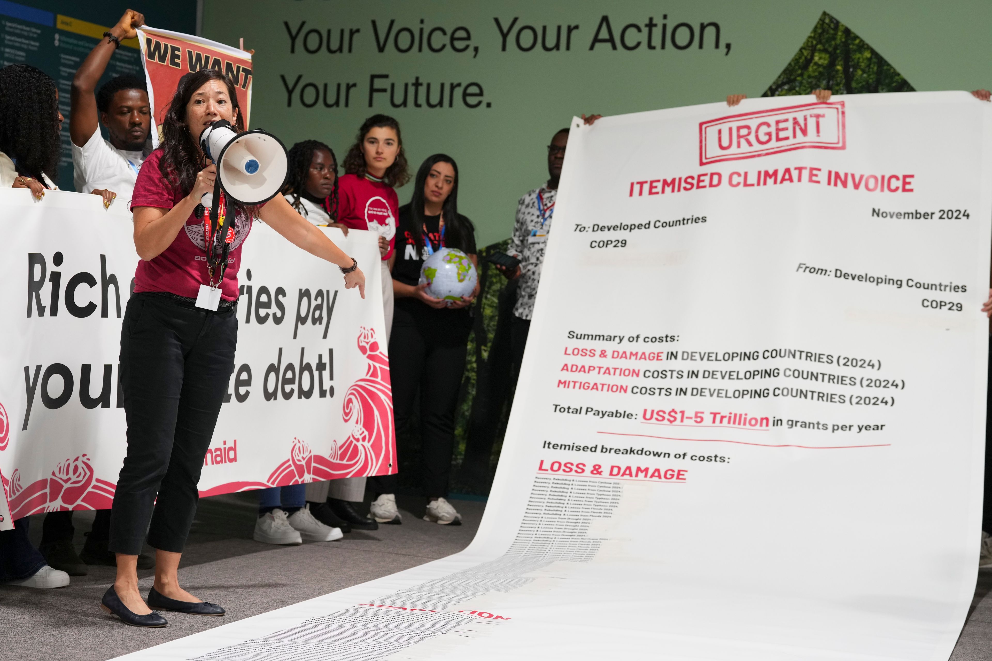 Activist Teresa Anderson leads a demonstration calling for climate finance during the COP29 U.N. Climate Summit, Thursday, Nov. 14, 2024, in Baku, Azerbaijan. (AP Photo/Peter Dejong)