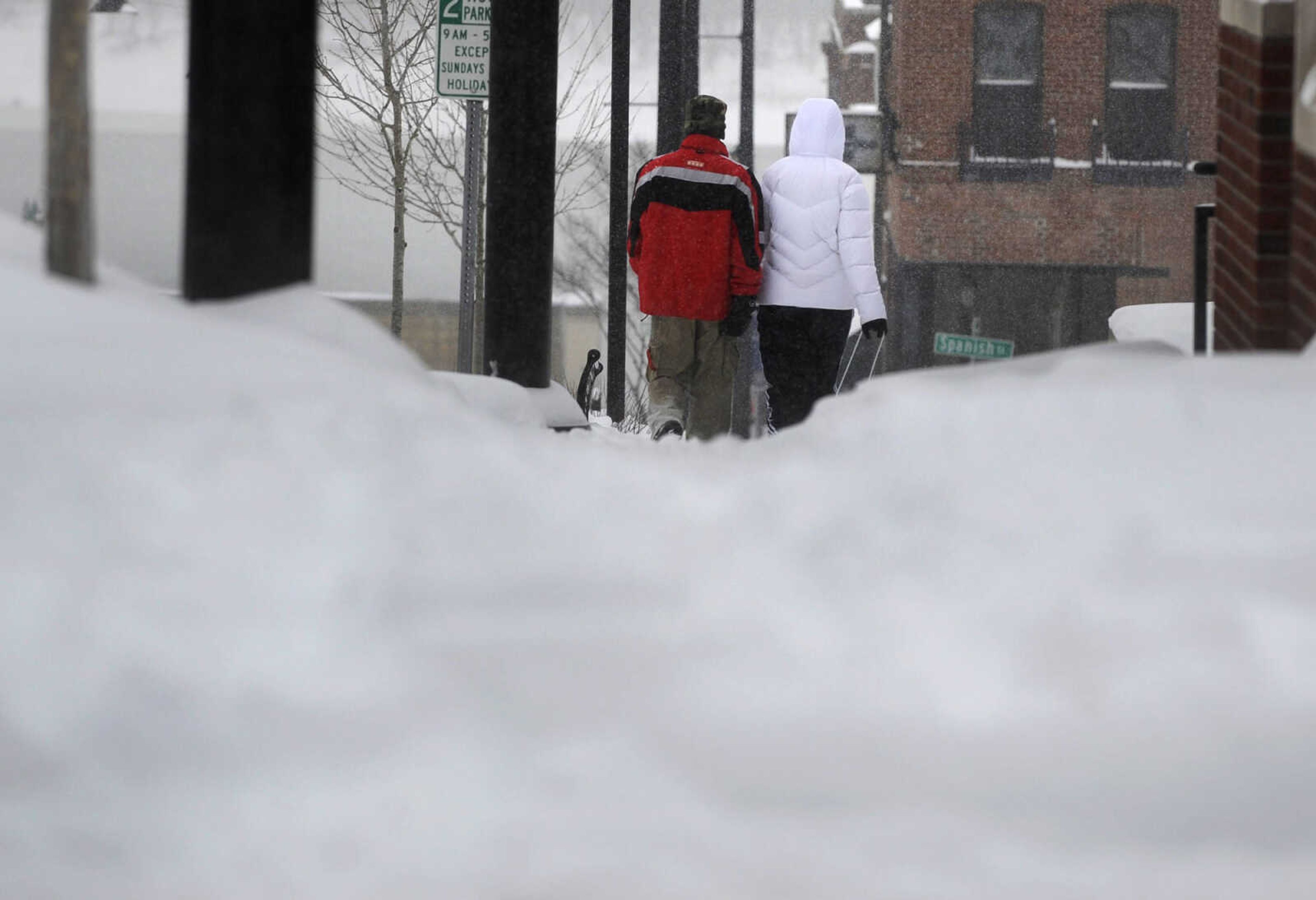 LAURA SIMON ~ lsimon@semissourian.com

Scott Norman, left, and Savanna Barker walk down Broadway to get a closer look at the snow along banks of  the Mississippi River, Monday morning, Feb. 16, 2015, in Cape Girardeau.